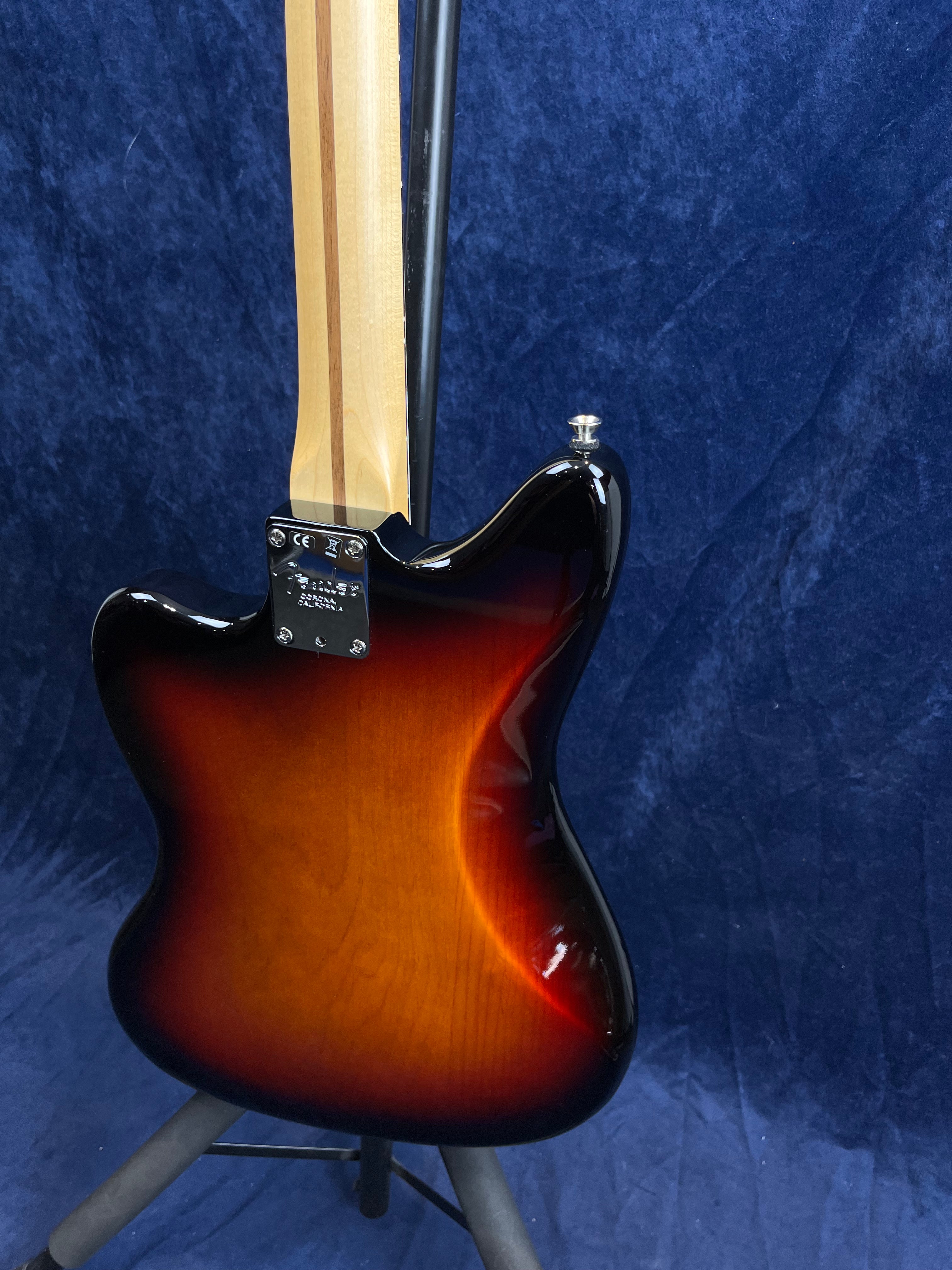 Sunburst finish electric guitar shown from the back, revealing a contoured body and a natural wood neck with two darker stripes.