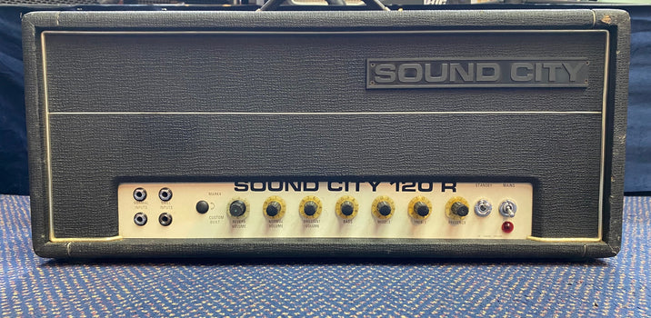 Sound City 120R amplifier head in black tolex with silver control panel, nine yellow knobs, four input jacks, and two toggle switches.