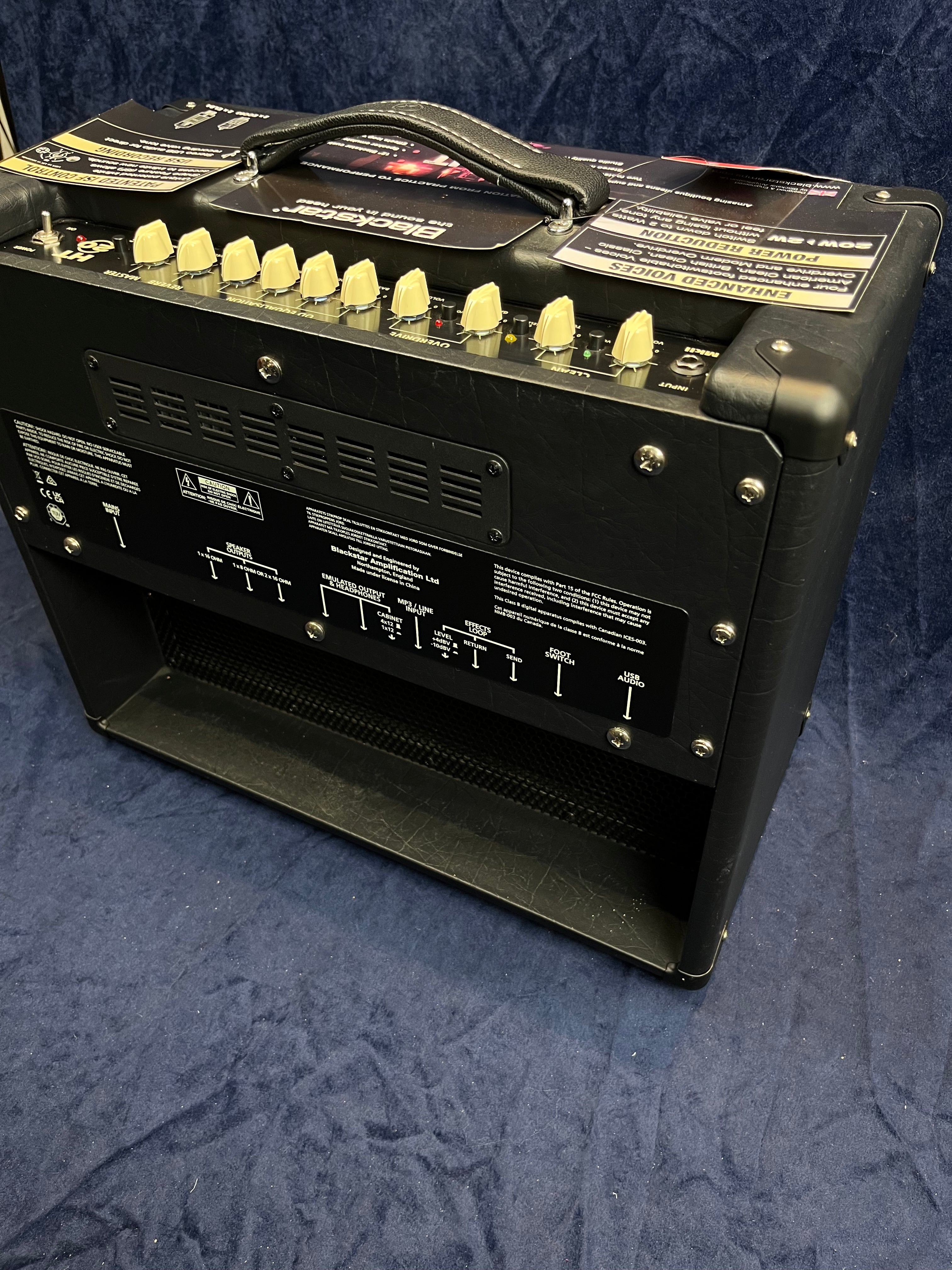 Blackstar amplifier with a top panel of cream-colored control knobs, a sturdy handle, and various input and output ports on the back.