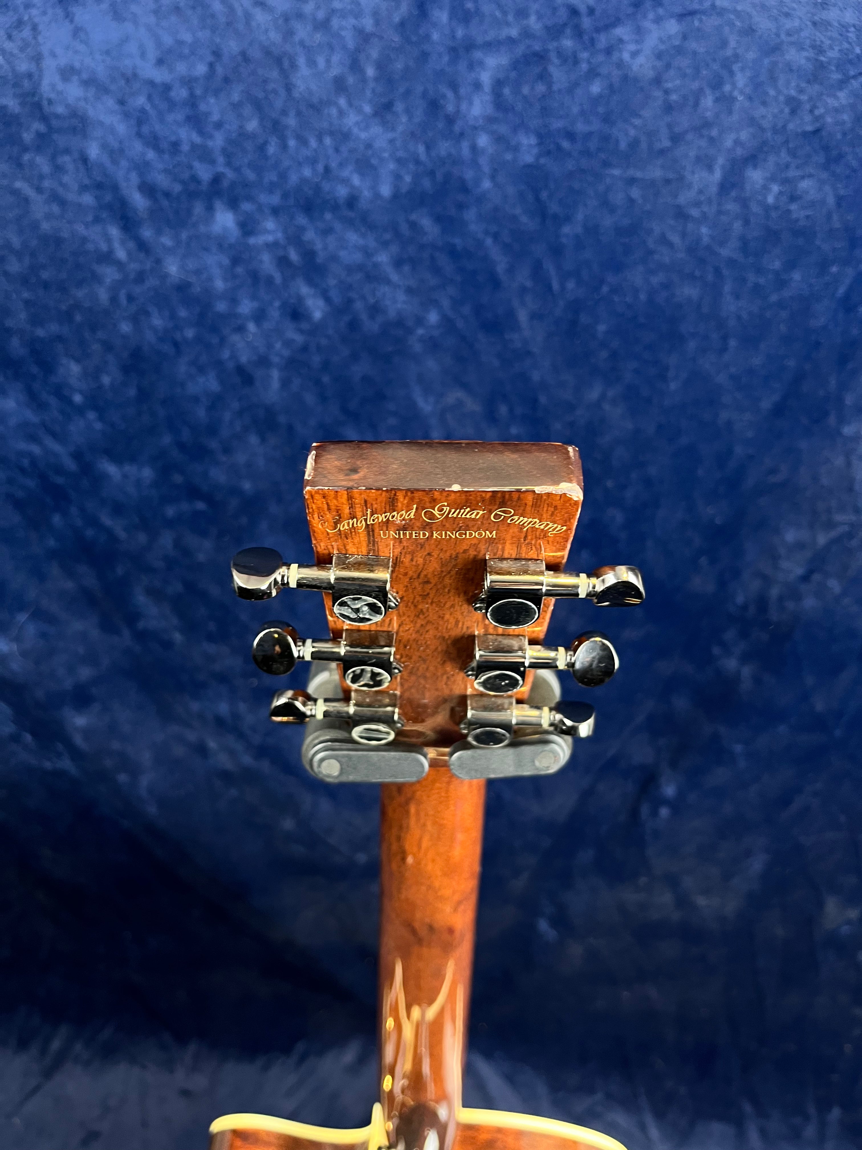 Rear headstock of an acoustic guitar with six metal tuning pegs, labeled "Tanglewood Guitar Company United Kingdom."