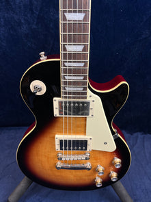 Epiphone electric guitar with a sunburst finish, two humbucker pickups, four gold control knobs, and a cream pickguard.