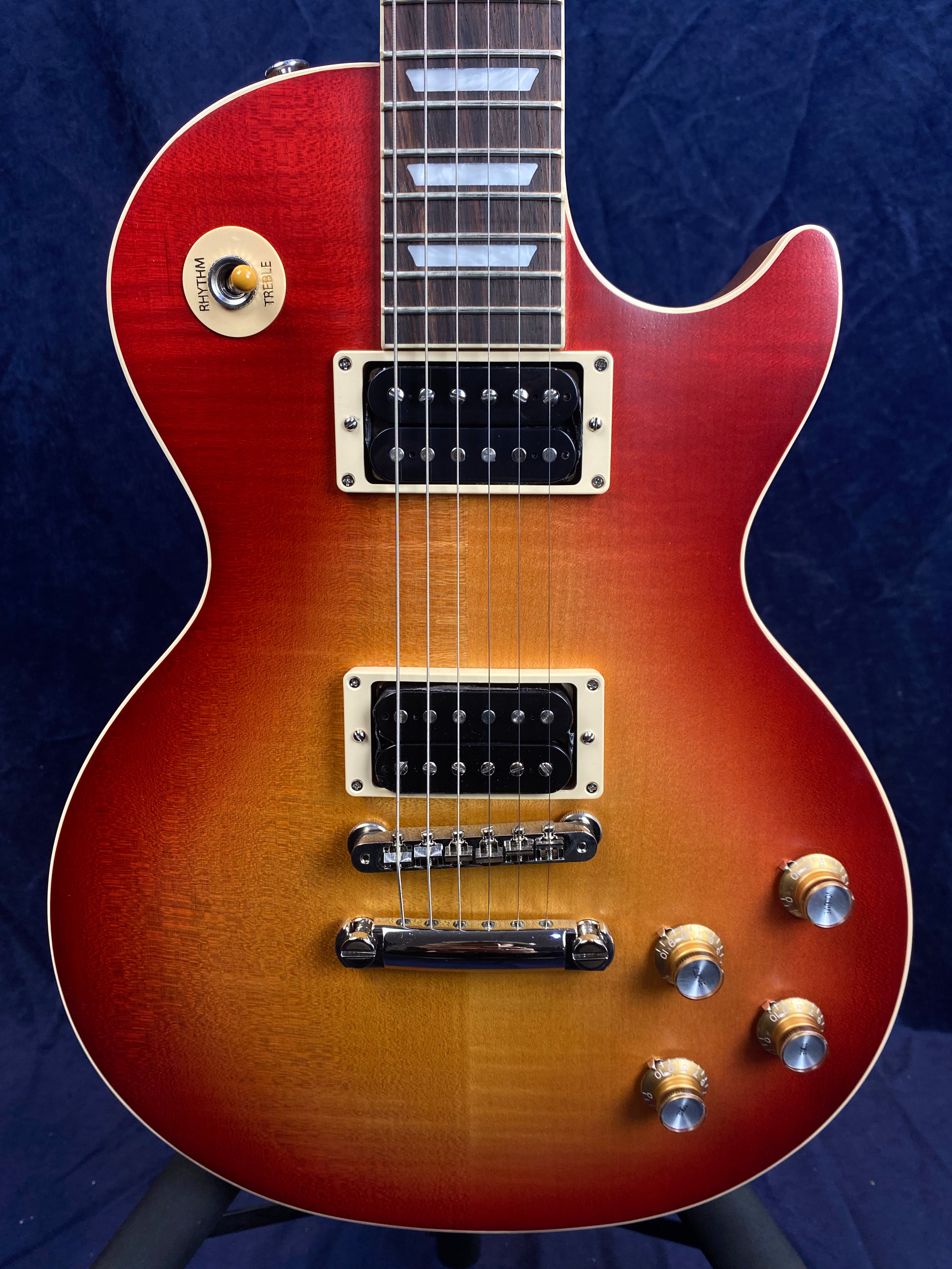Sunburst electric guitar with a single cutaway, chrome hardware, four knobs, two black humbucker pickups, and a three-way toggle switch.