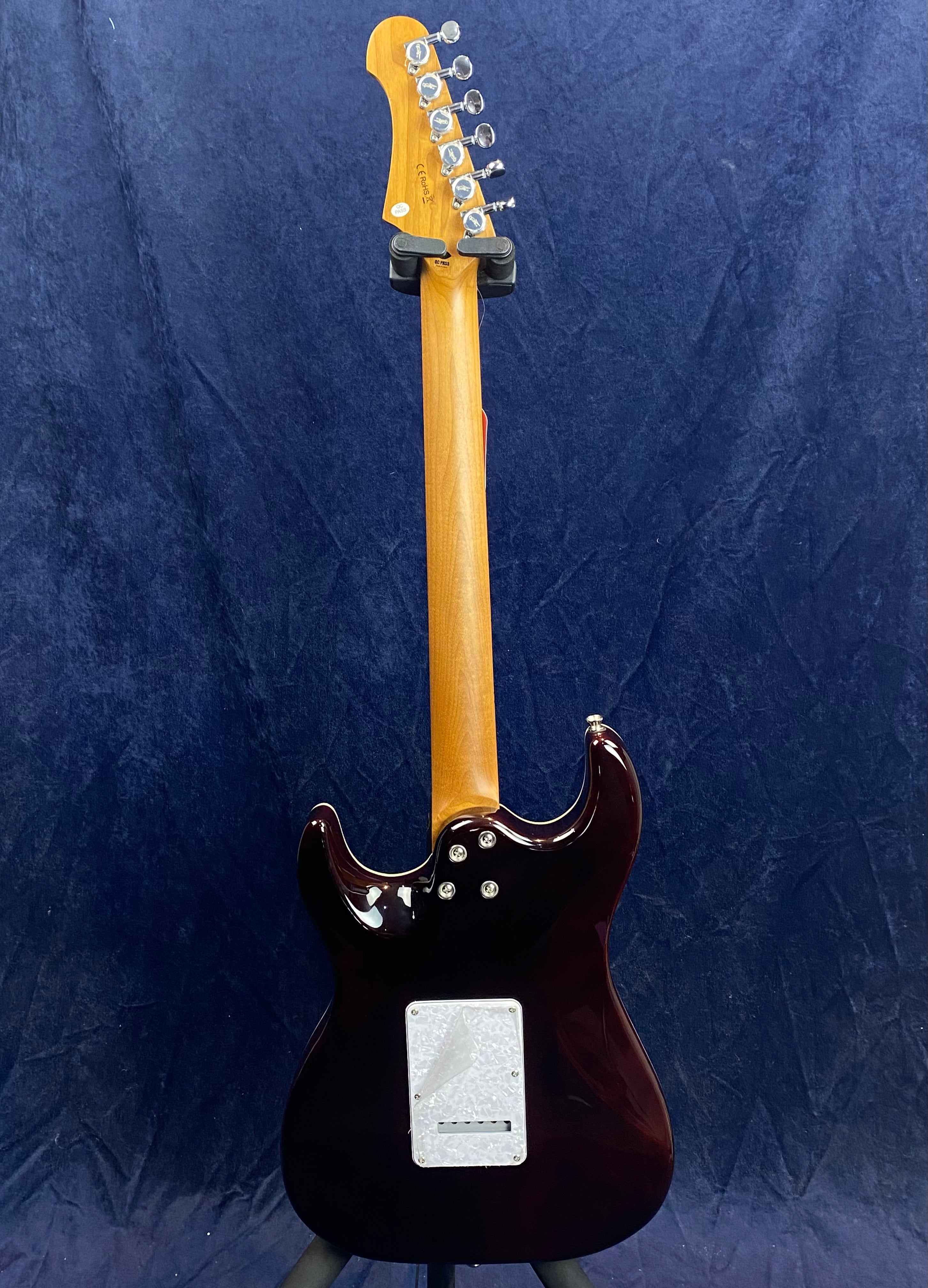 Electric guitar shown from the back, featuring a natural wood neck, dark glossy body, and a white plastic control plate near the bottom.