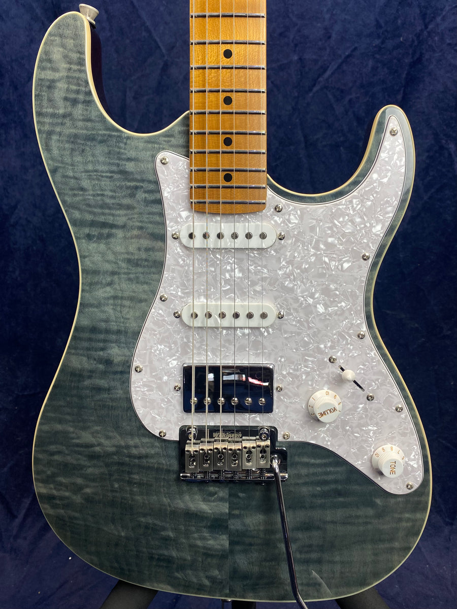 Electric guitar with a gray quilted maple top, pearloid pickguard, three pickups, and a maple neck with dot inlays and chrome bridge hardware.