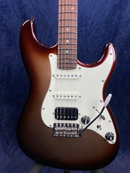 Electric guitar with a brown sunburst finish, white pickguard, two single-coil pickups, one black humbucker pickup, and a tremolo arm.