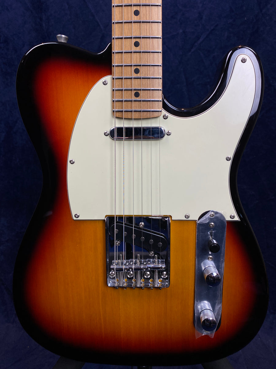 Sunburst electric guitar with a white pickguard, chrome bridge, and two control knobs on a metal plate, maple neck with dot inlays.