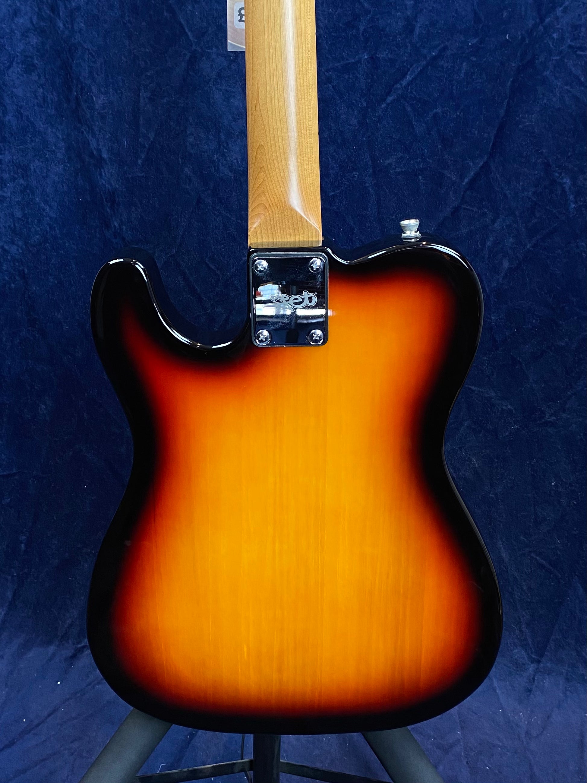 Sunburst-finish electric guitar shown from the back, displaying a glossy body with a wood neck and a metal neck plate with four screws.