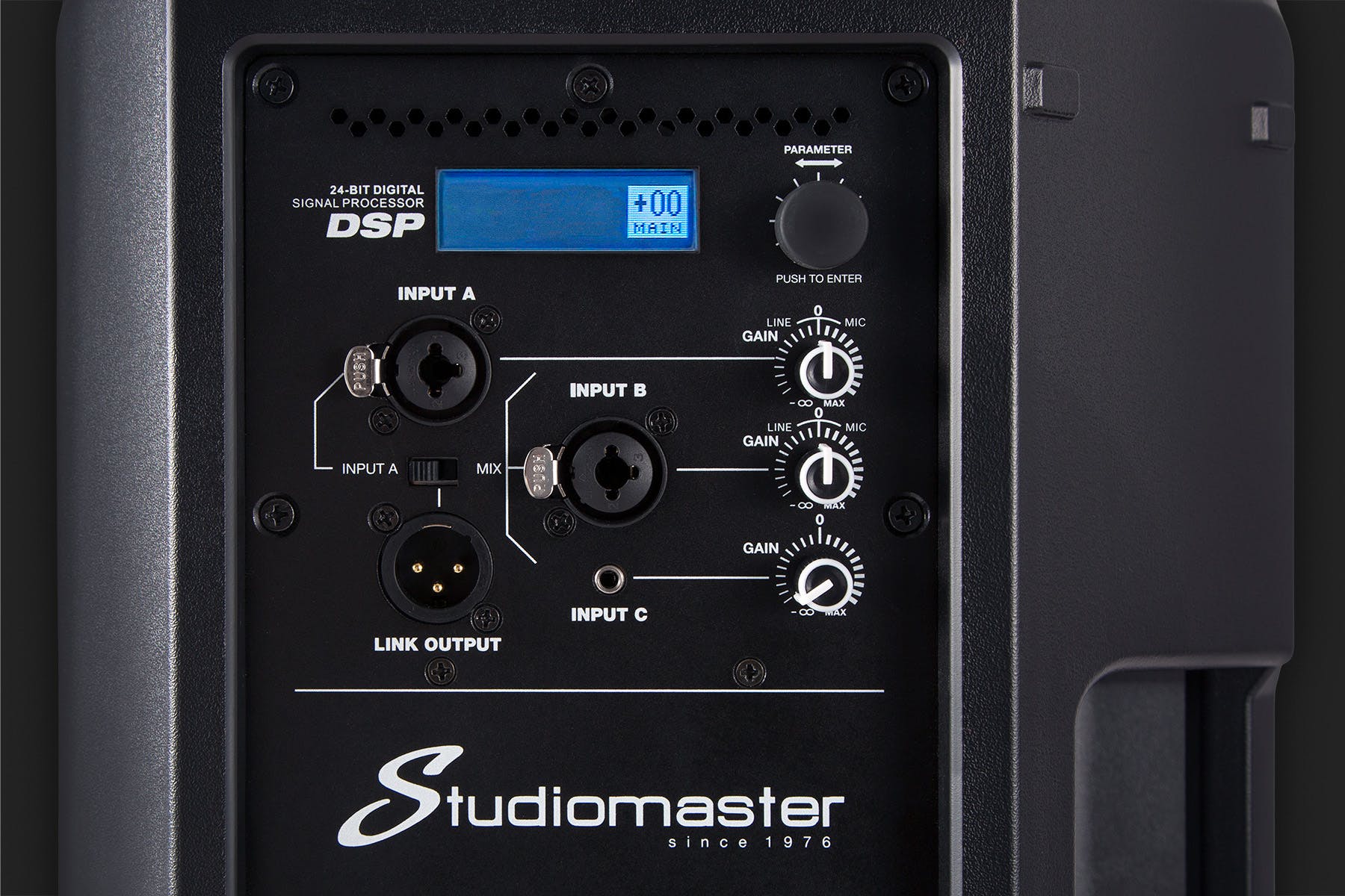 Studiomaster speaker control panel with three combo inputs, gain knobs, a digital display, parameter dial, and a link output connector.