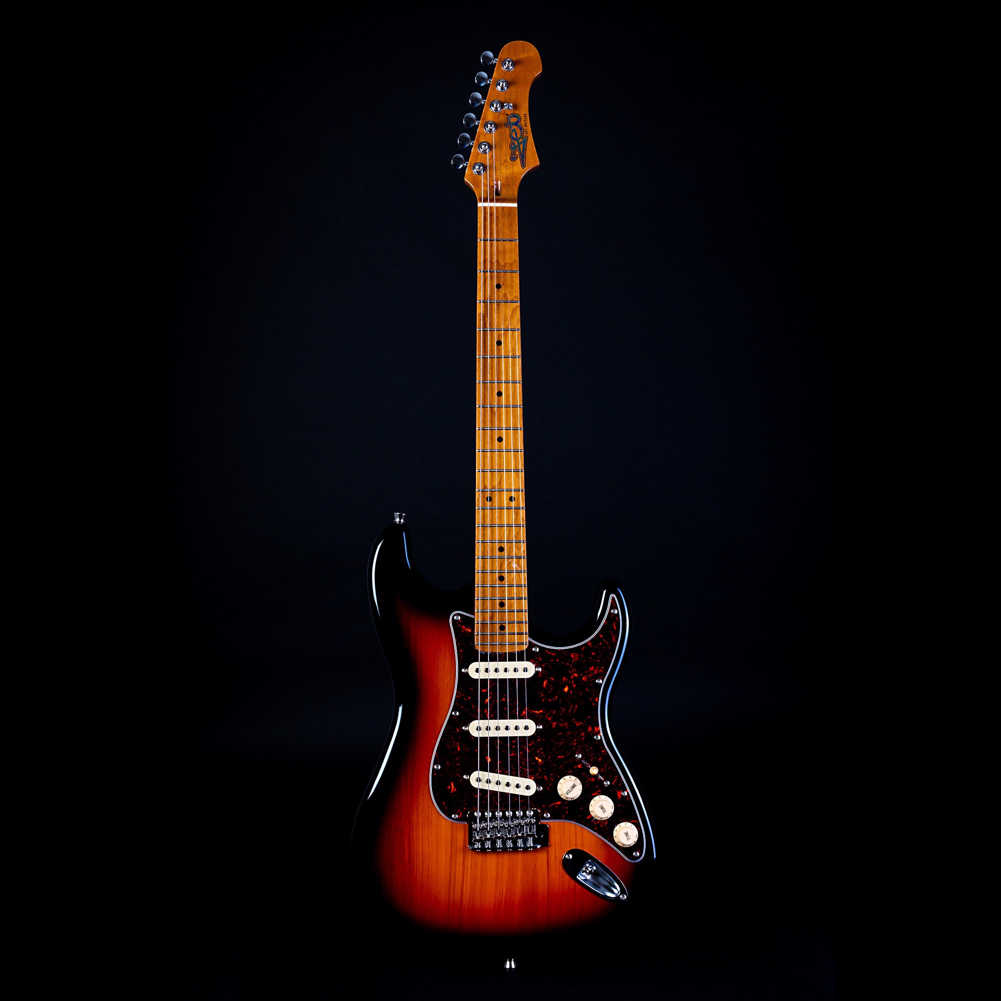 Electric guitar with a sunburst finish, white pickups, dark pickguard, maple neck, and silver tuning pegs, shown upright on a black background.