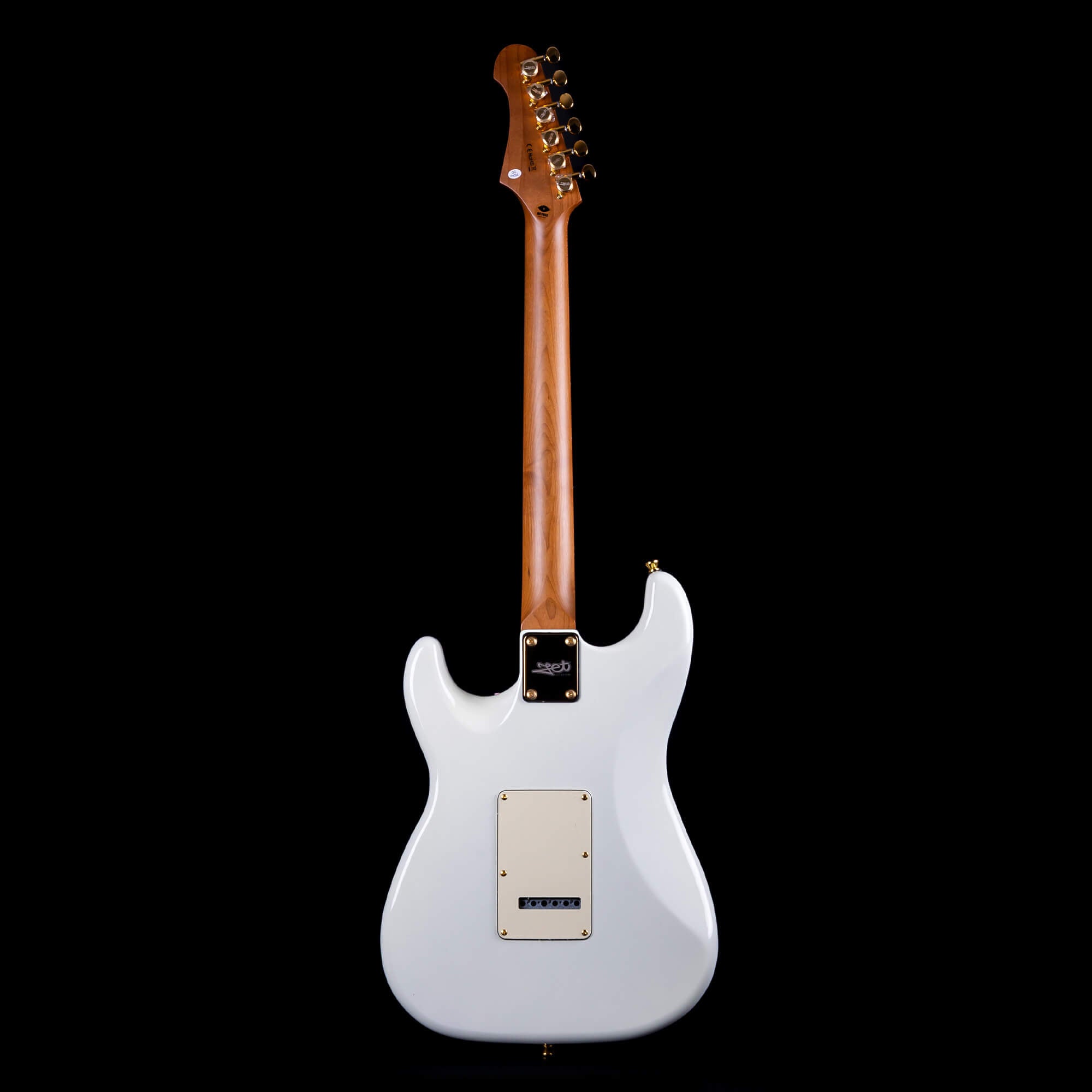 White electric guitar seen from the back, showing a natural wood neck, six tuning pegs, and a rectangular rear cavity cover.