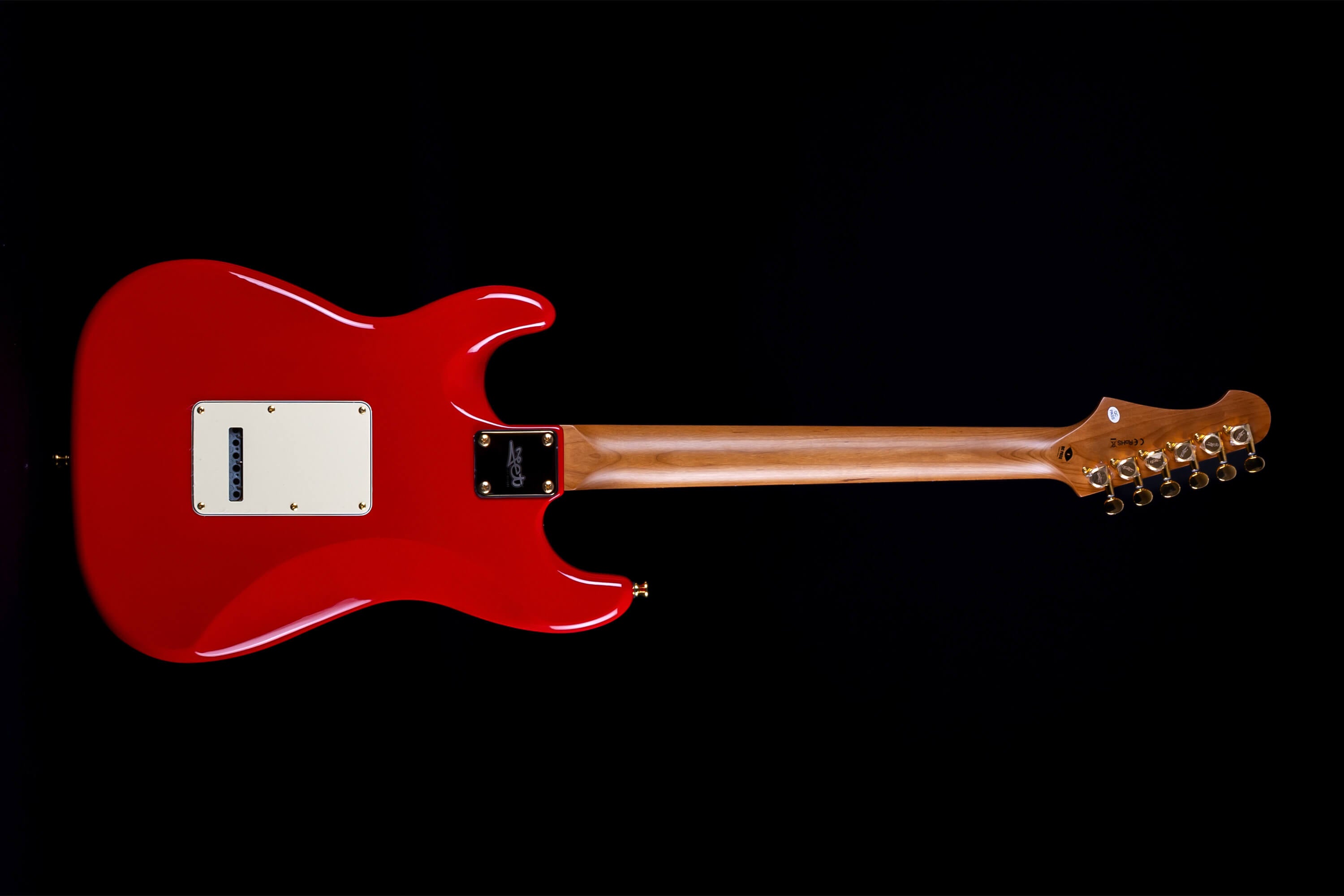 Jet Guitars electric guitar shown from the back, glossy red body, natural wood neck, six gold tuners, and a cream back plate.