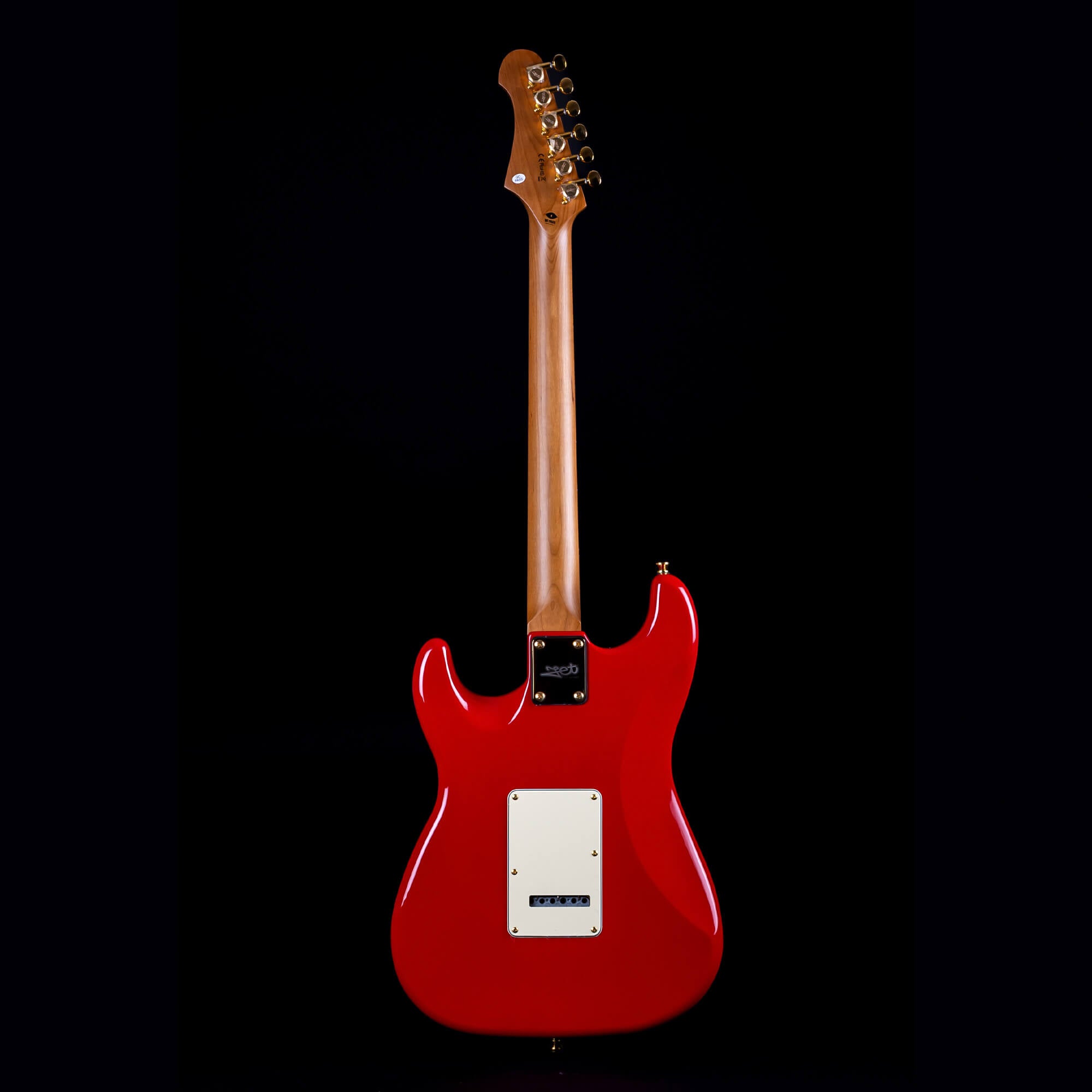 A Jet Guitar with a glossy red body, natural wood neck, gold tuning pegs, and a rectangular white panel on the back.