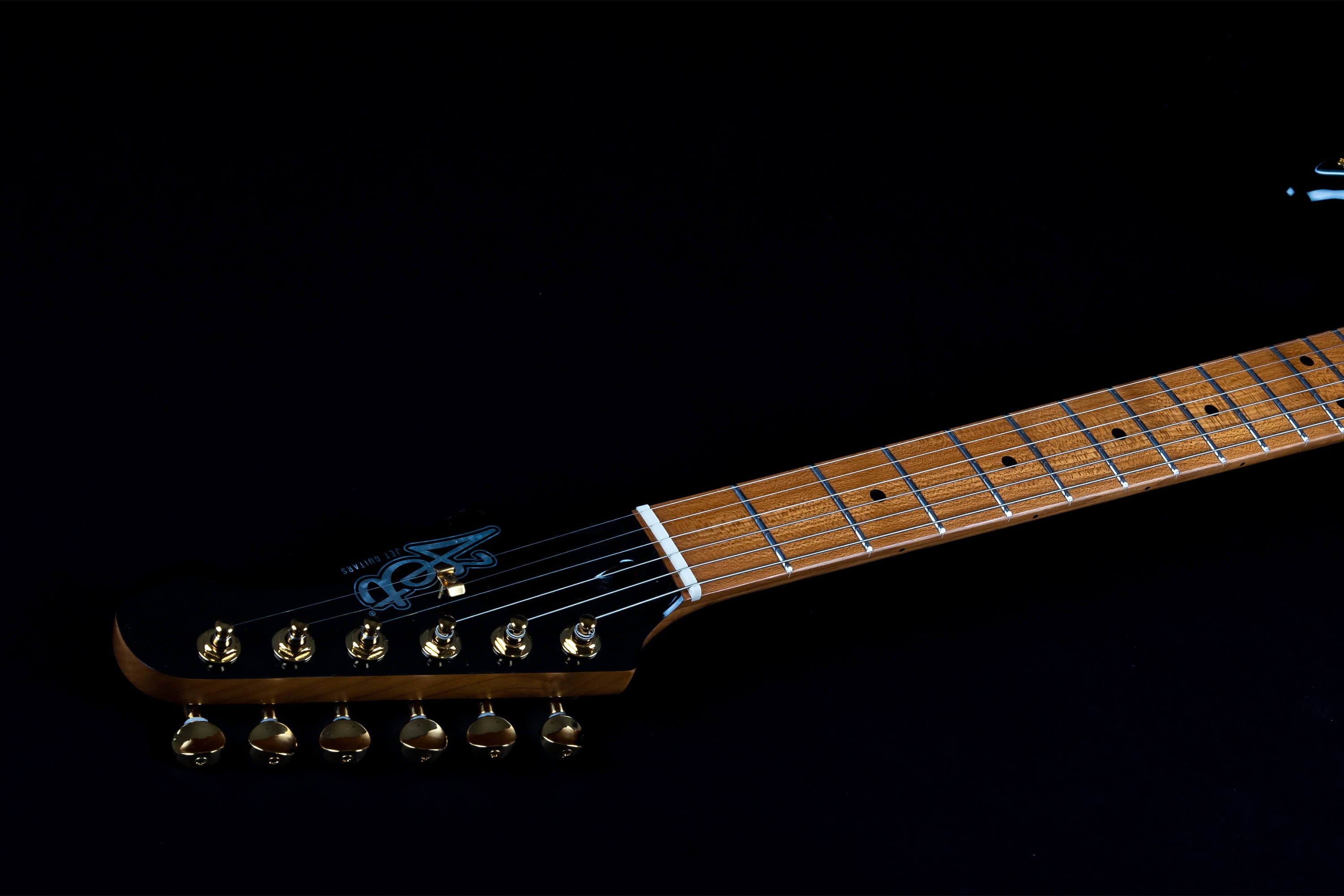 Wood-finished electric guitar neck with dot inlays and gold tuning pegs, black headstock features a blue logo.