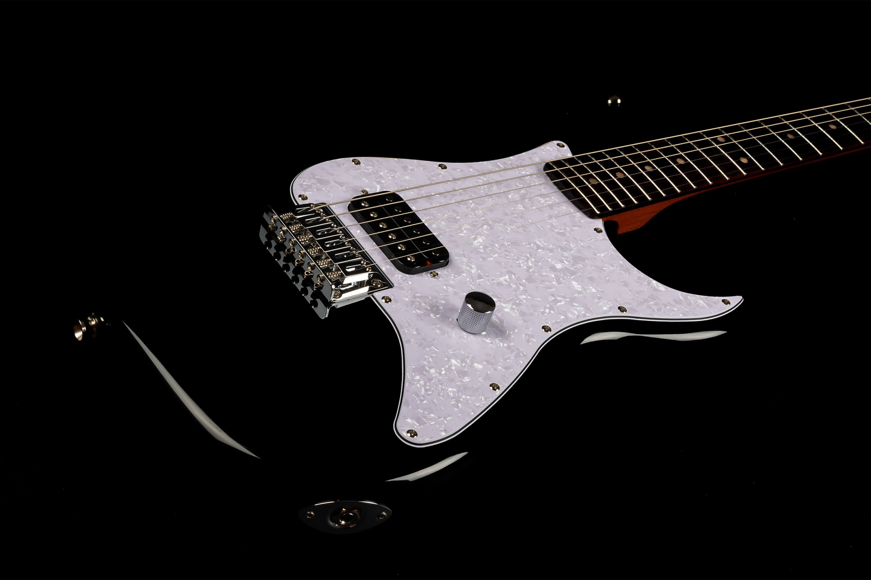 Sleek black electric guitar with a white pearloid pickguard, six strings, chrome hardware, single pickup, and one control knob.
