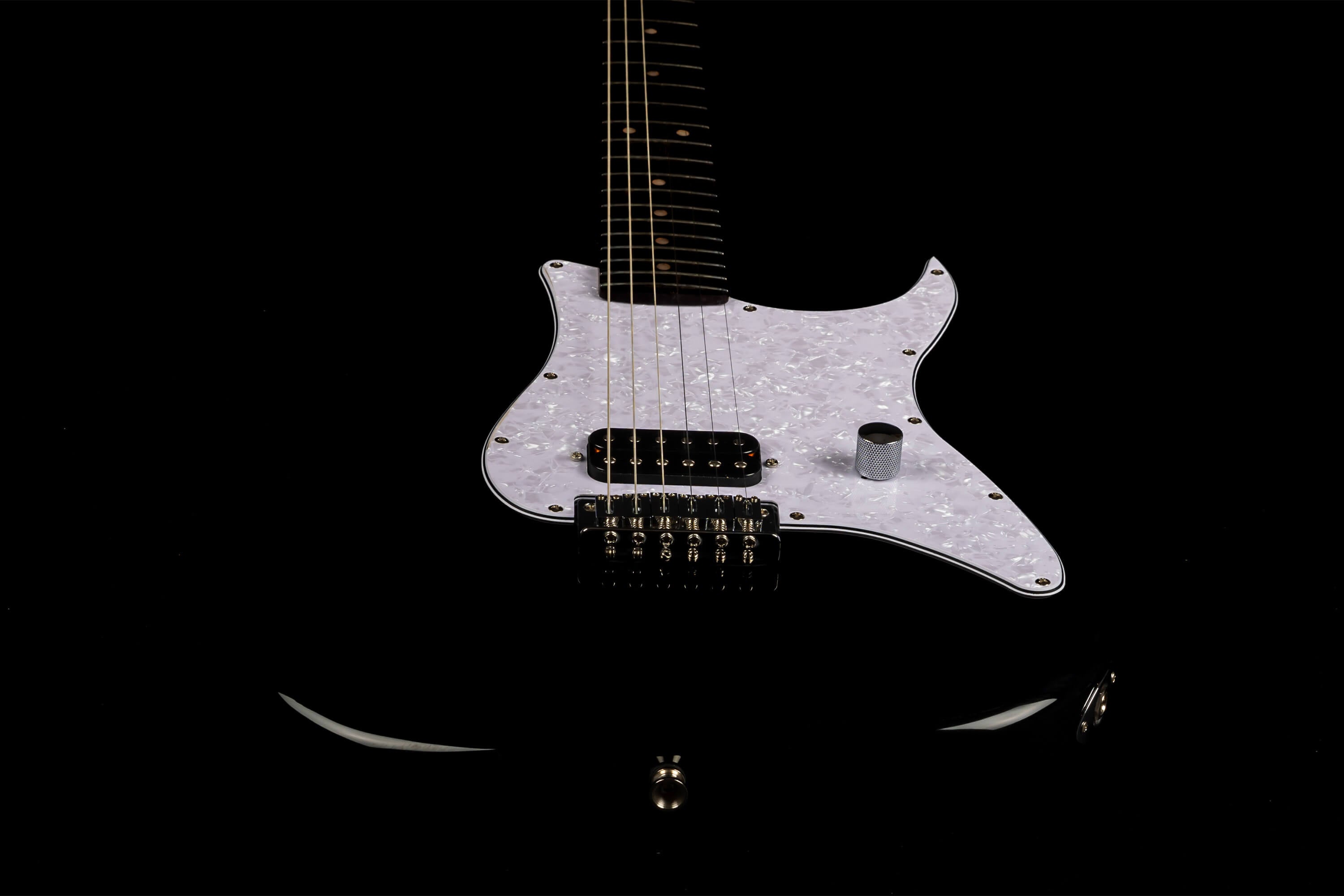 Black electric guitar body with a pearly white pickguard, single humbucker pickup, one metal knob, and six strings visible.