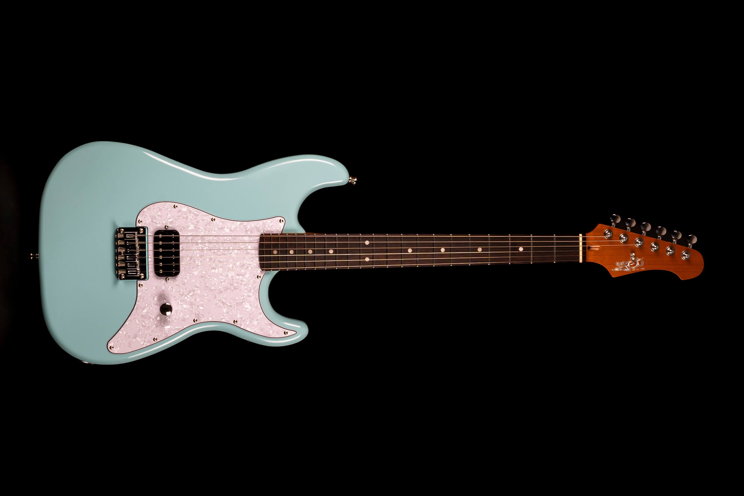 Electric guitar with a light blue body, white pearloid pickguard, dark fretboard, single black pickup, and six tuning pegs on a brown headstock.