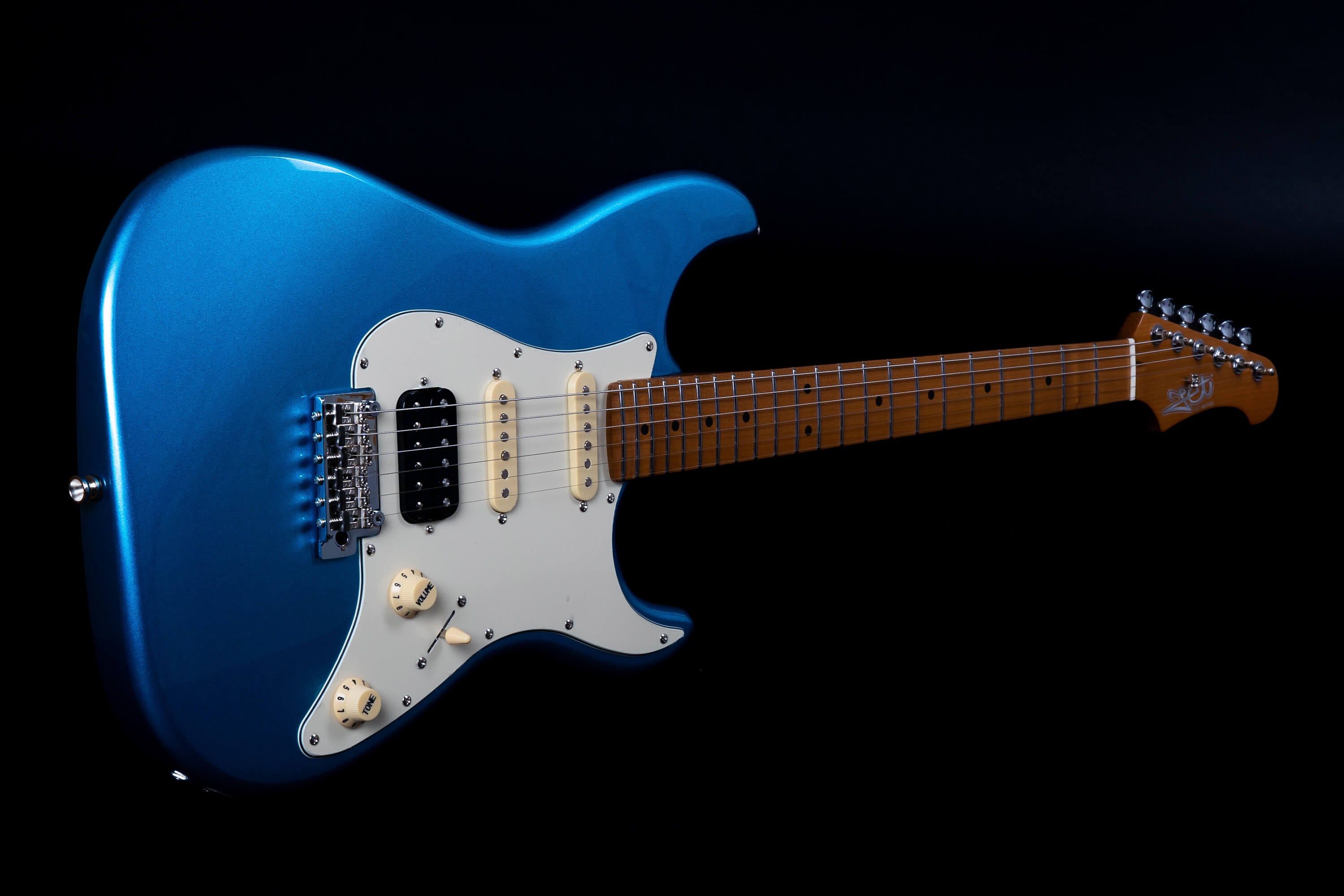 Metallic blue electric guitar with white pickguard, two single-coil pickups, one humbucker, maple fretboard, and chrome hardware.