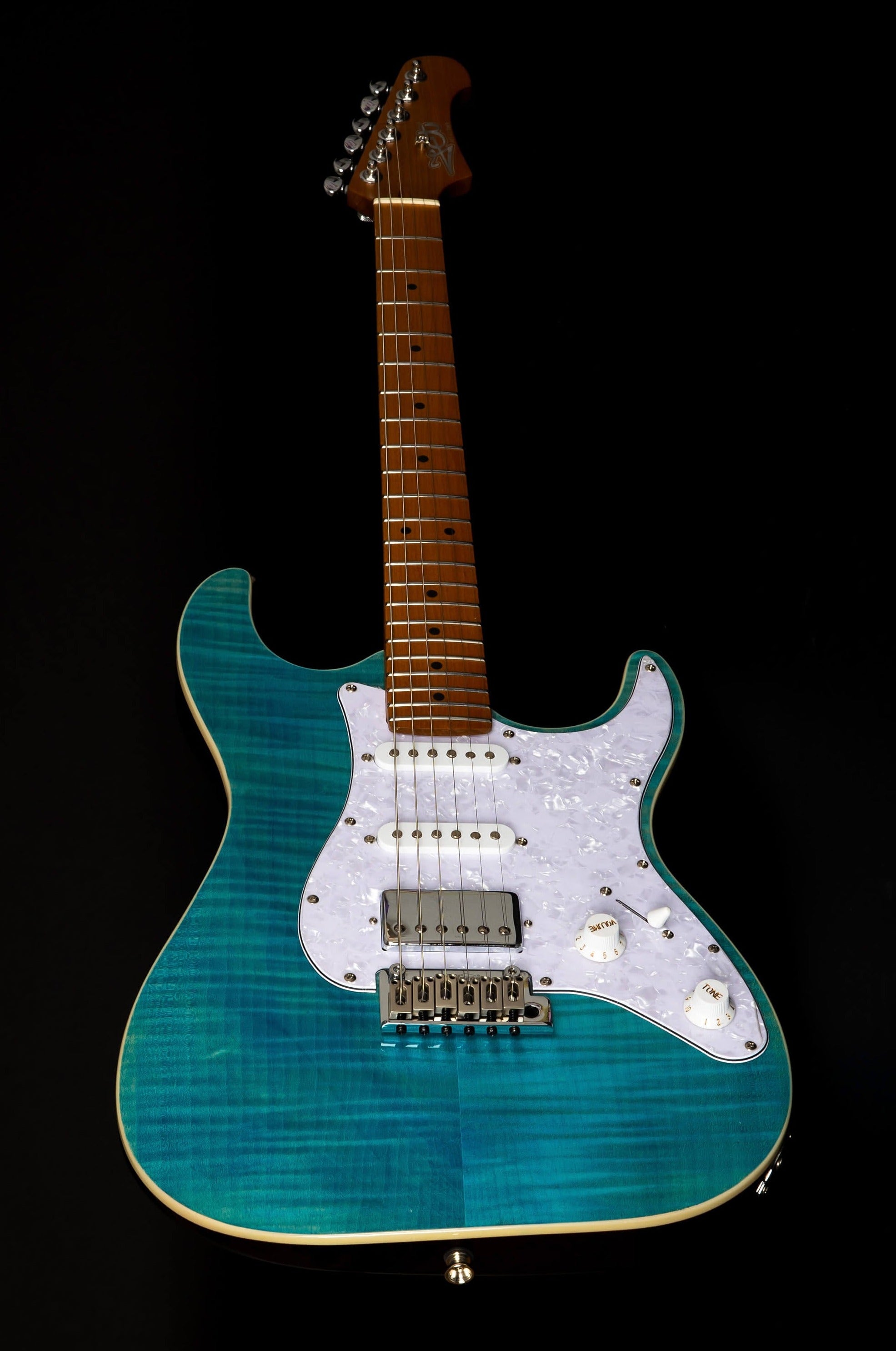Electric guitar with a glossy blue-green finish, white pickguard, three pickups, five control knobs, and a maple neck with silver tuning pegs.