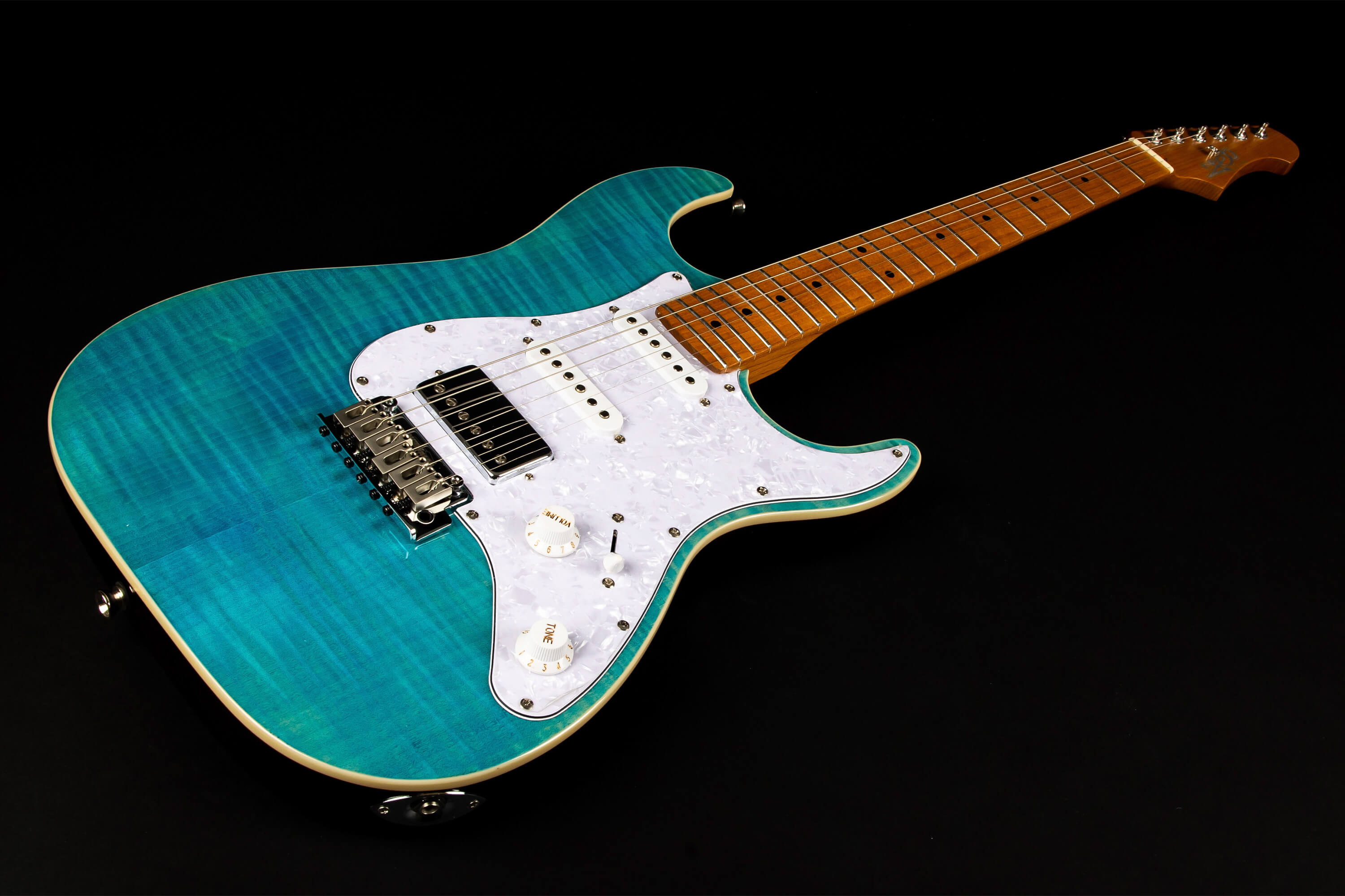Electric guitar with a glossy turquoise blue body, white pearloid pickguard, three pickups, and a maple wood neck with dot inlays.