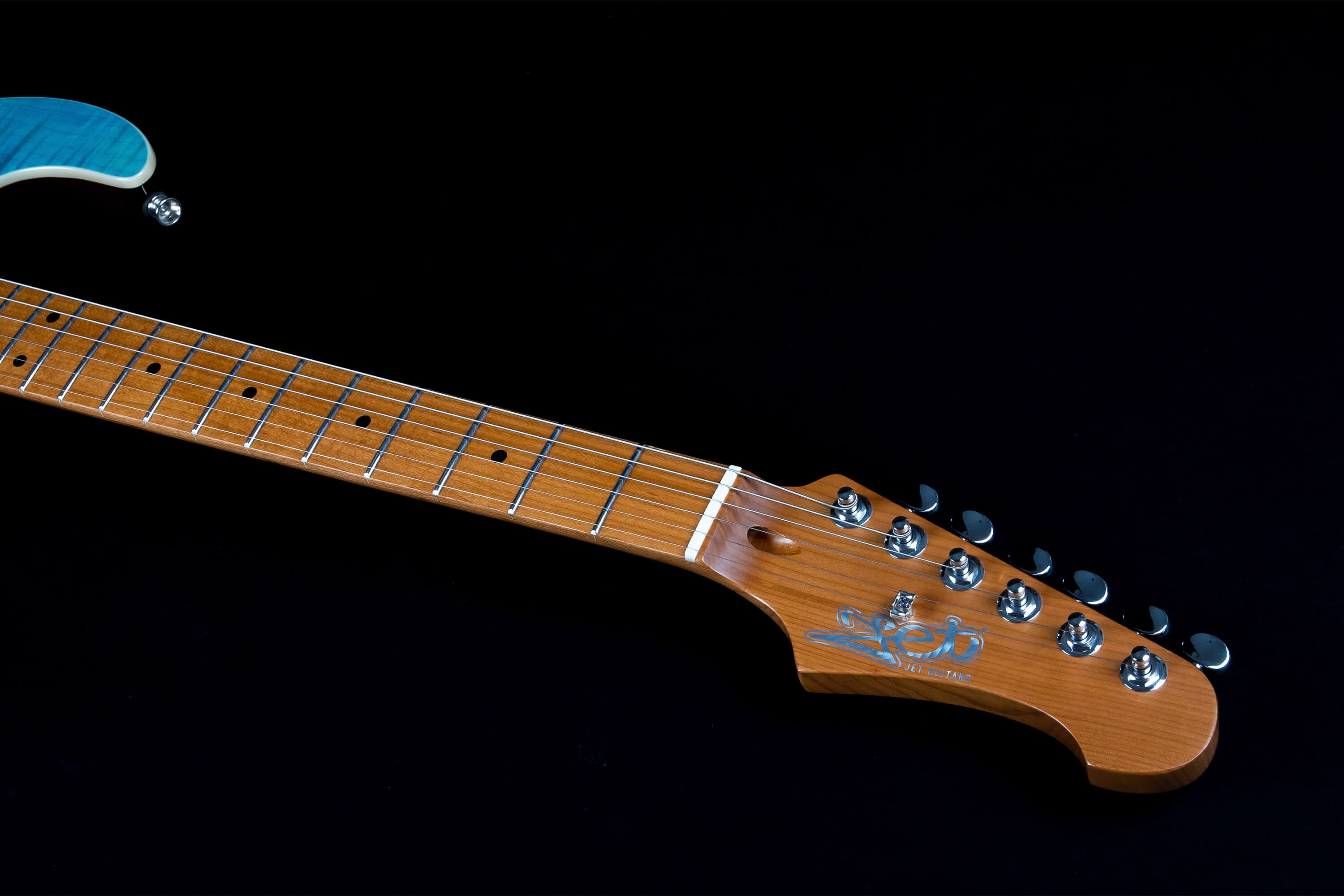 Electric guitar neck and headstock showing six metal tuning pegs, a maple fretboard with dot inlays, and a glimpse of a blue guitar body.