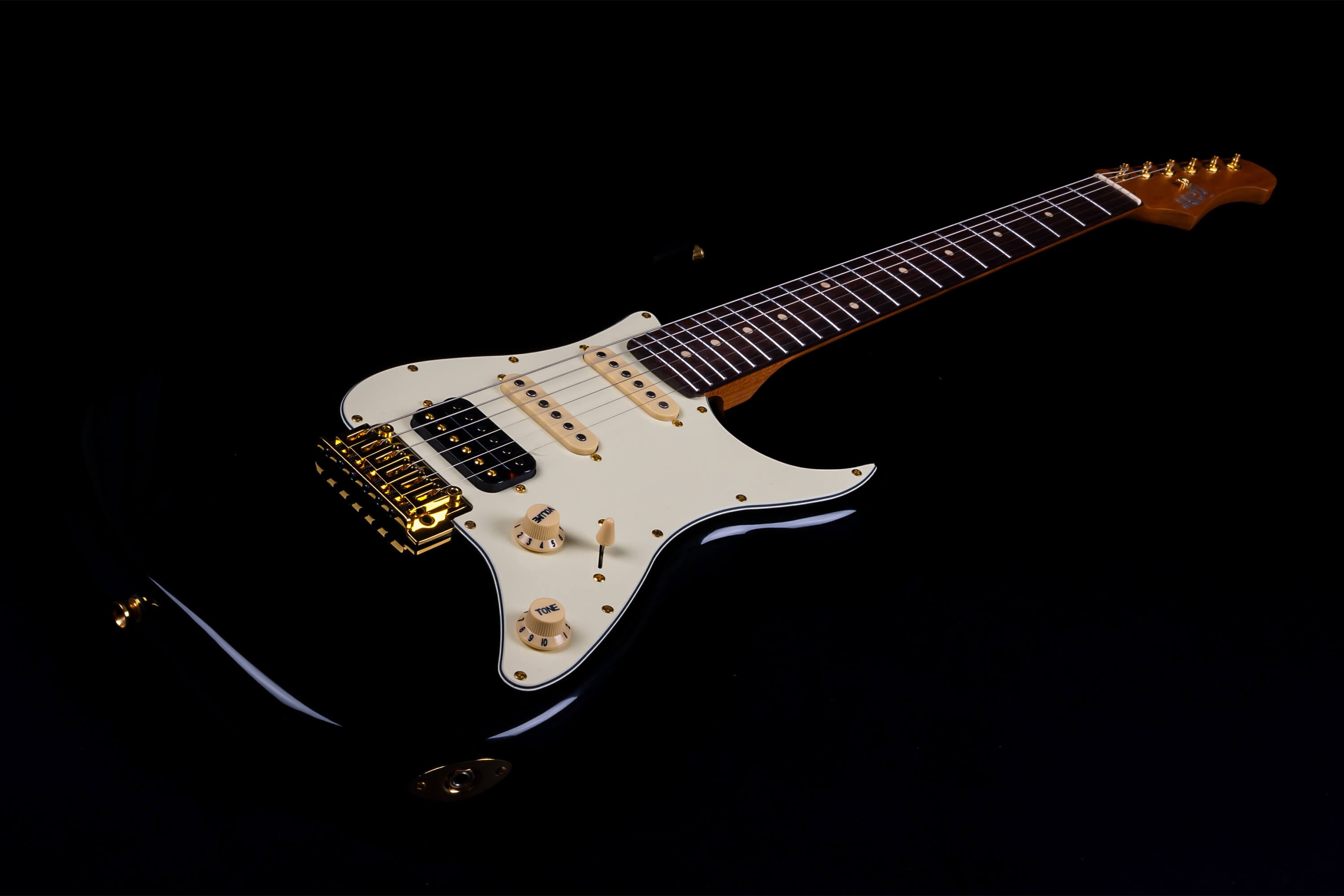 Jet electric guitar with a glossy black body, cream pickguard, gold hardware, and a dark brown fretboard.