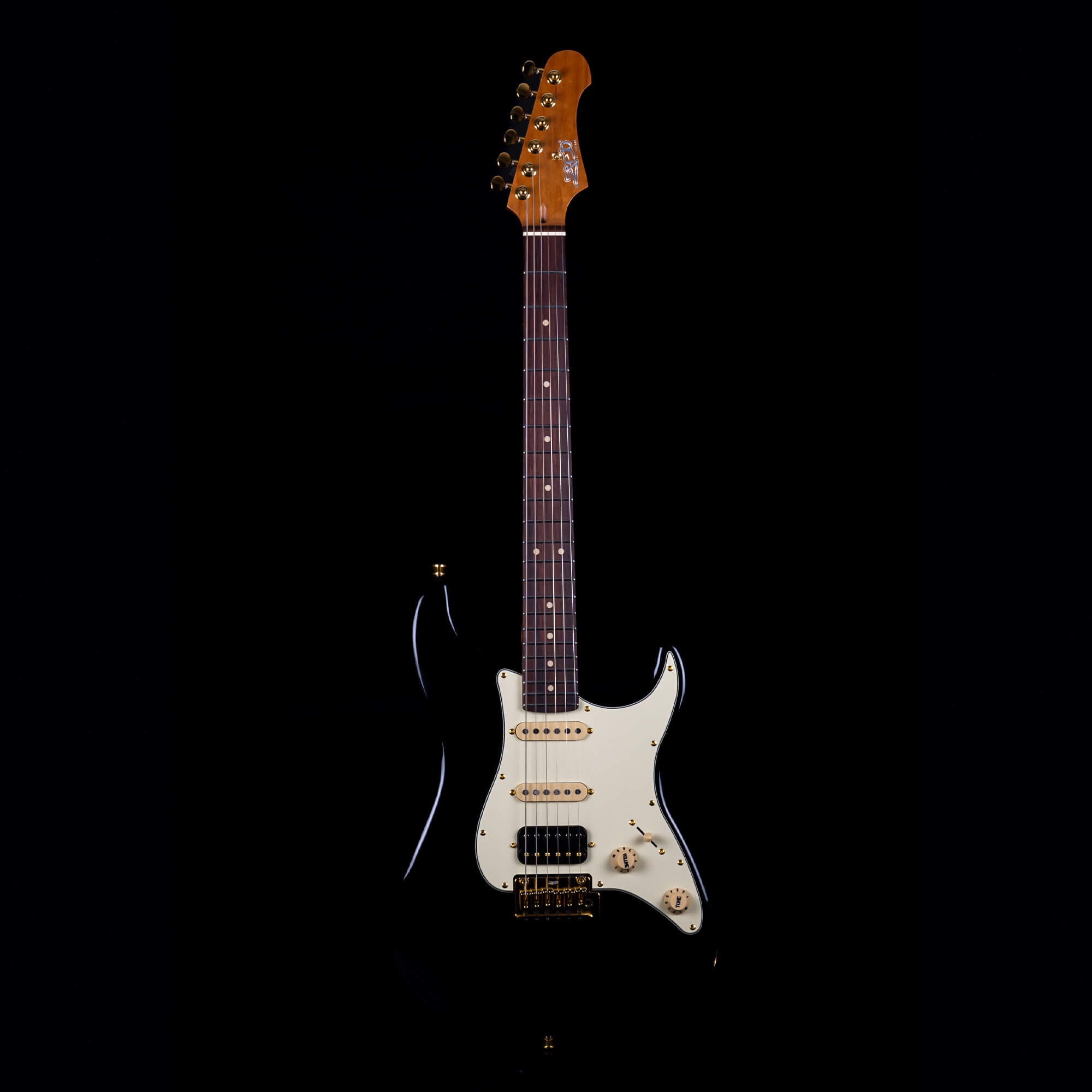 Electric Jet Guitar with a glossy black body, cream pickguard, rosewood fretboard, and gold hardware, displayed against a solid black background.