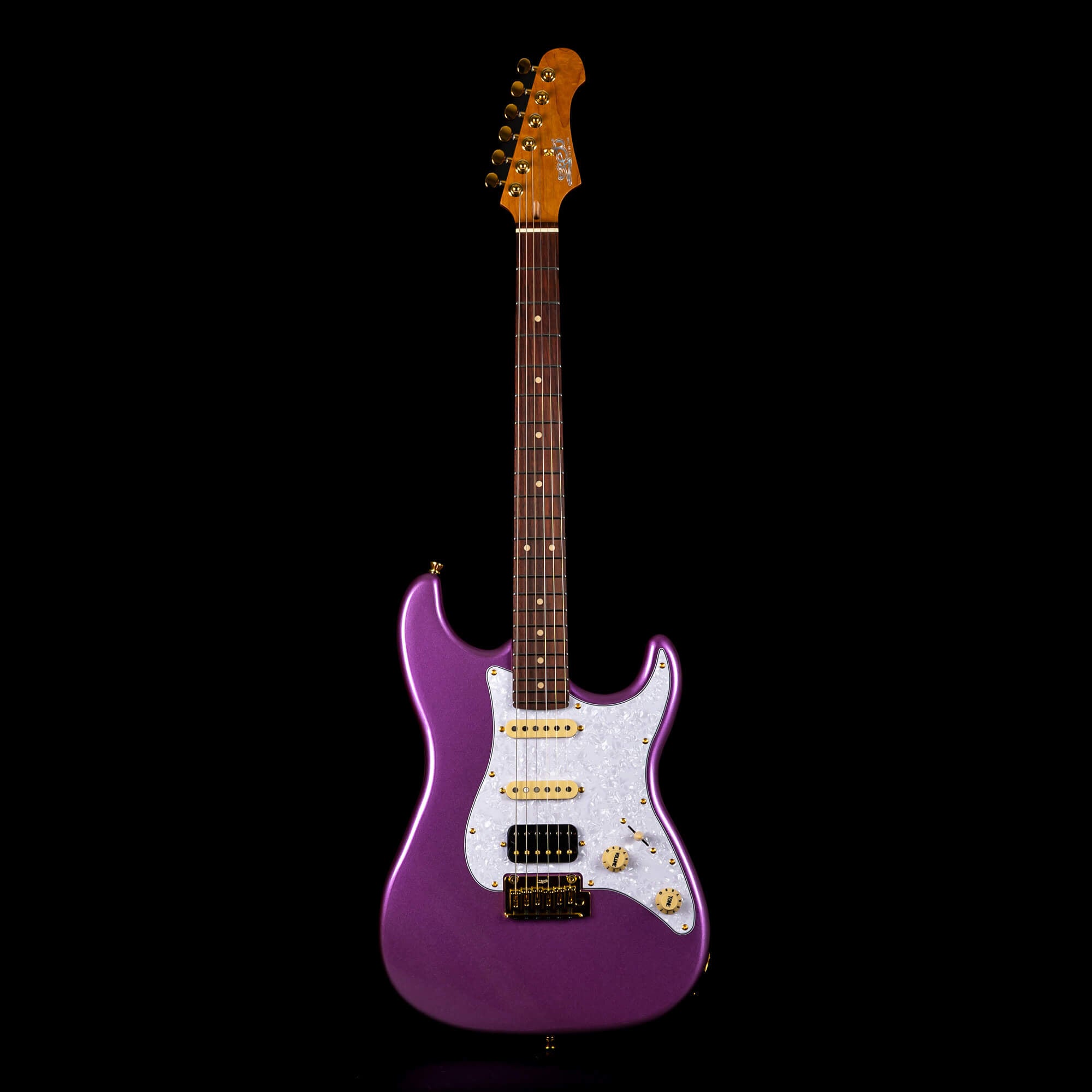 Purple electric guitar with a white pearloid pickguard, three pickups, gold hardware, and a rosewood fretboard against a black background.