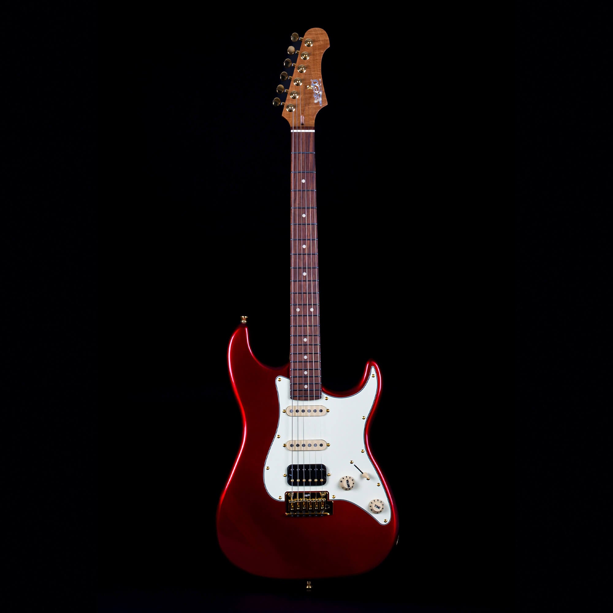Red electric guitar with a white pickguard, rosewood fretboard, gold hardware, and three pickups, shown upright against a black background.