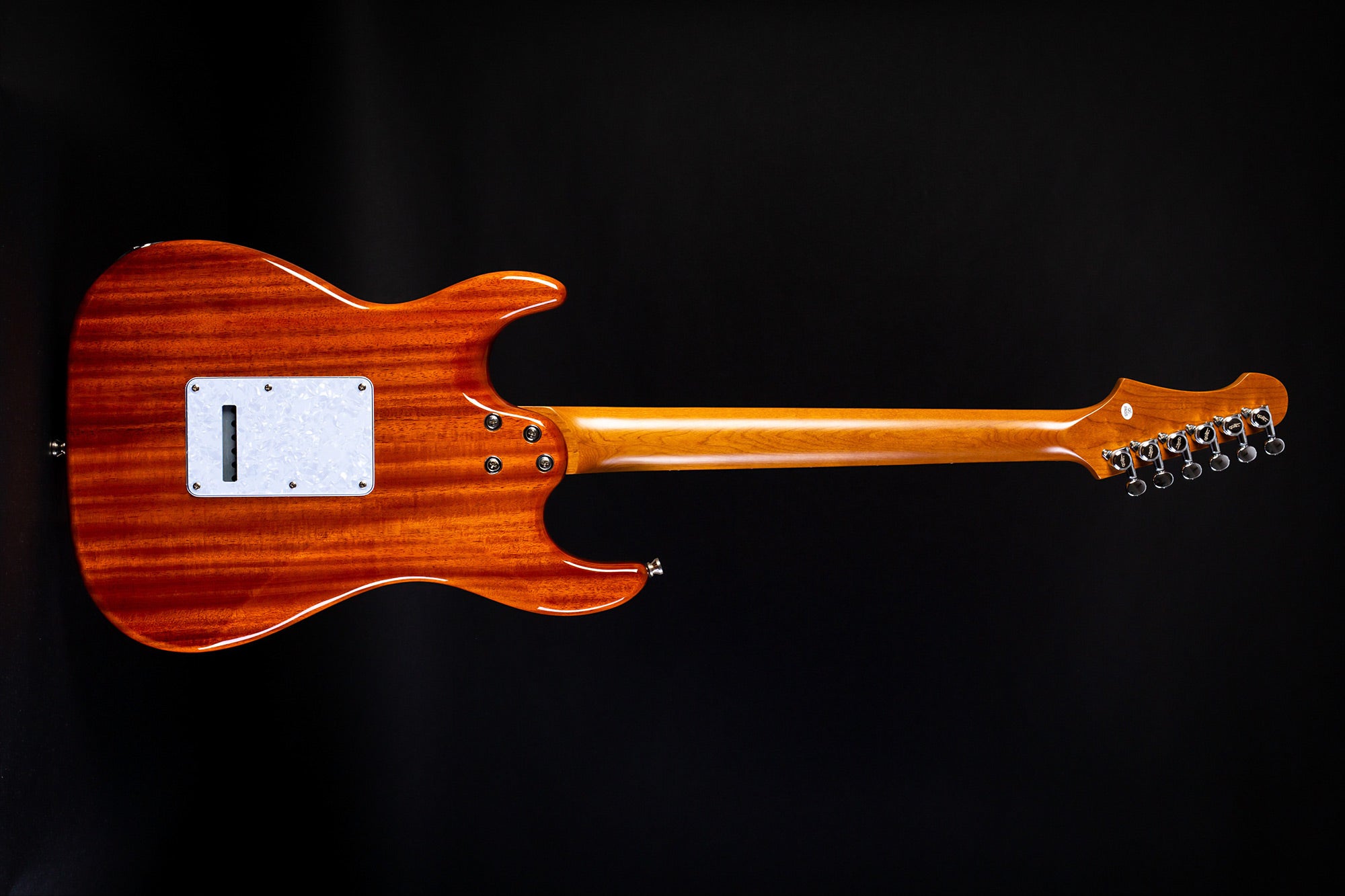 Electric guitar shown from the back, with a glossy brown wood body, a light wood neck, and six tuning pegs on the right side of the headstock.