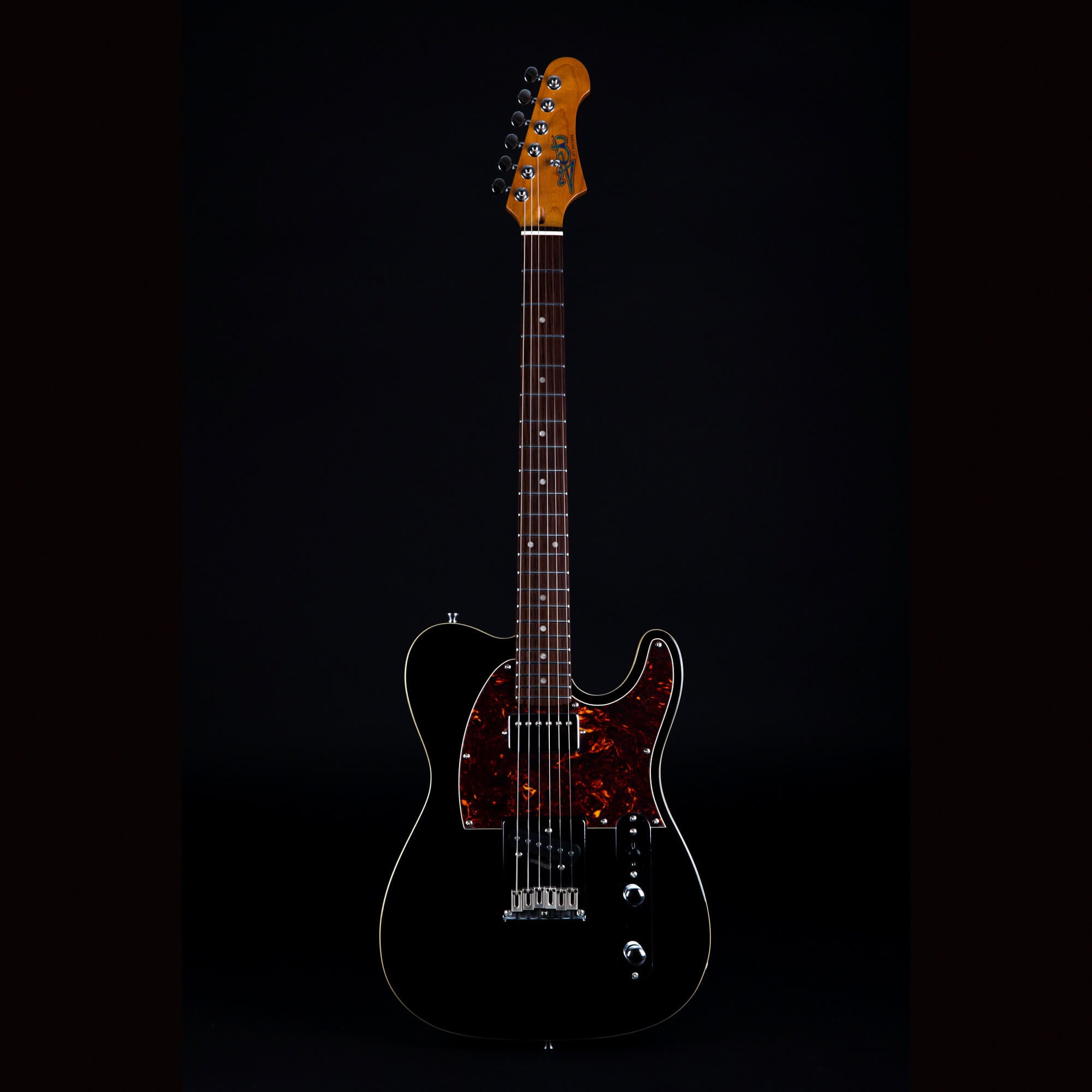 Black electric guitar with a dark tortoiseshell pickguard, chrome hardware, rosewood fretboard, and a natural wood headstock.
