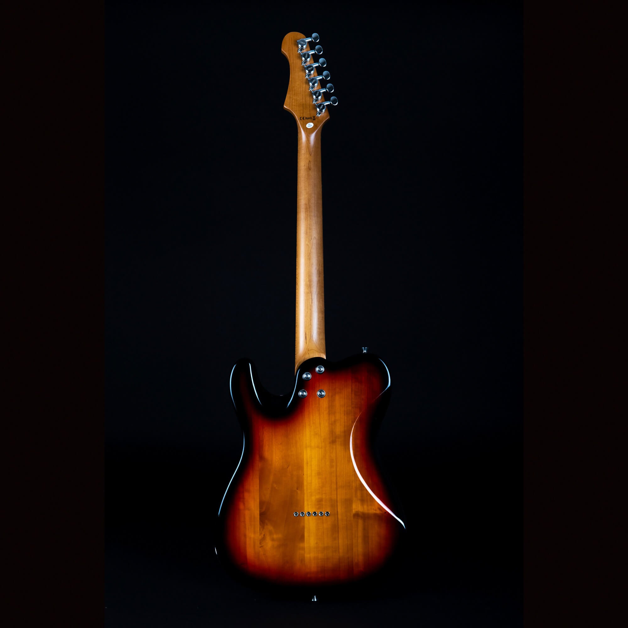 Sunburst electric guitar shown from the back, highlighting its wooden neck and glossy dark-edged body with six string ferrules visible.