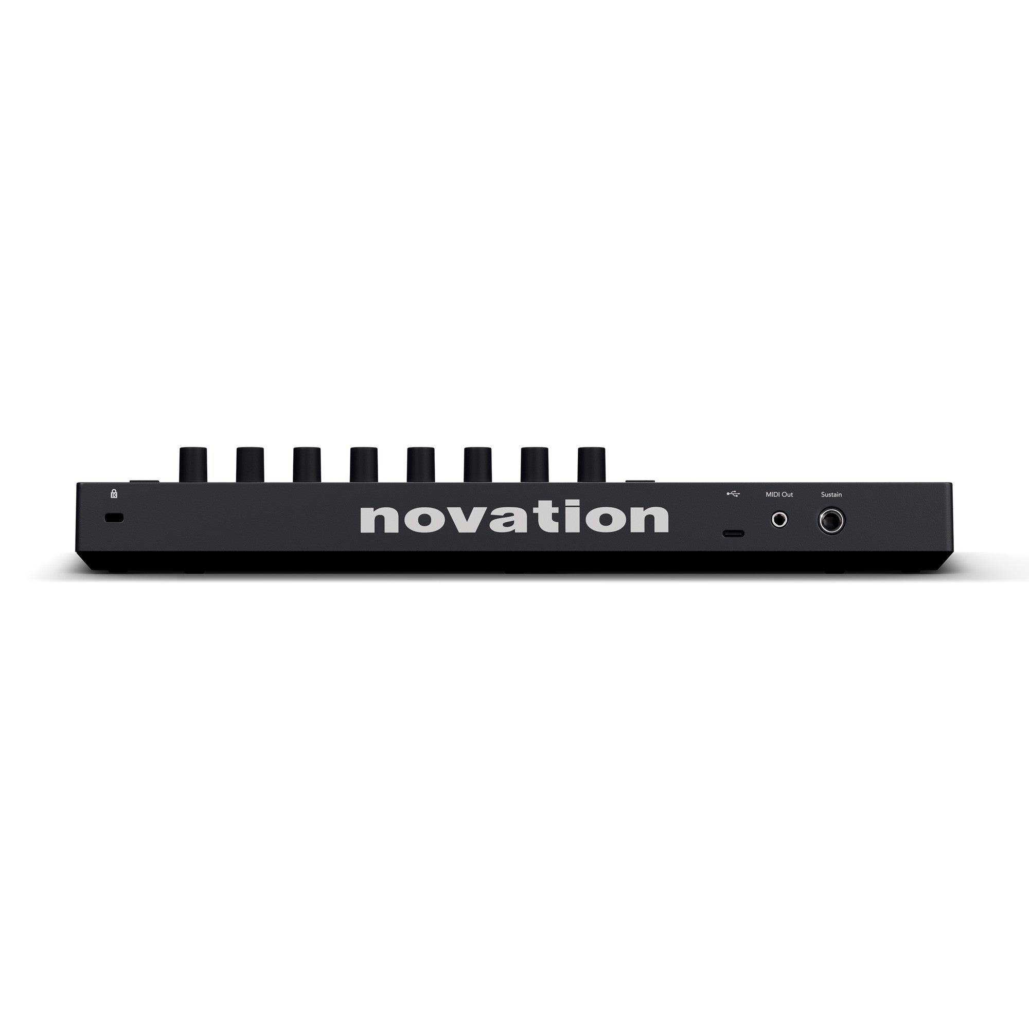 Black Novation midi controller viewed from the back, showing multiple knobs, USB, MIDI out, and sustain pedal ports.