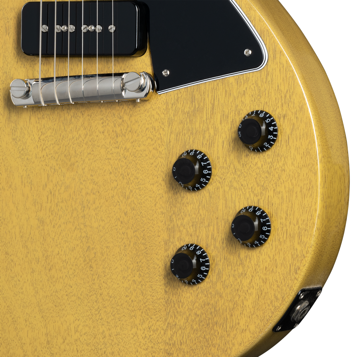 Yellow electric guitar body showing four black control knobs, a metal bridge, black pickup, and a black pickguard with silver screws.