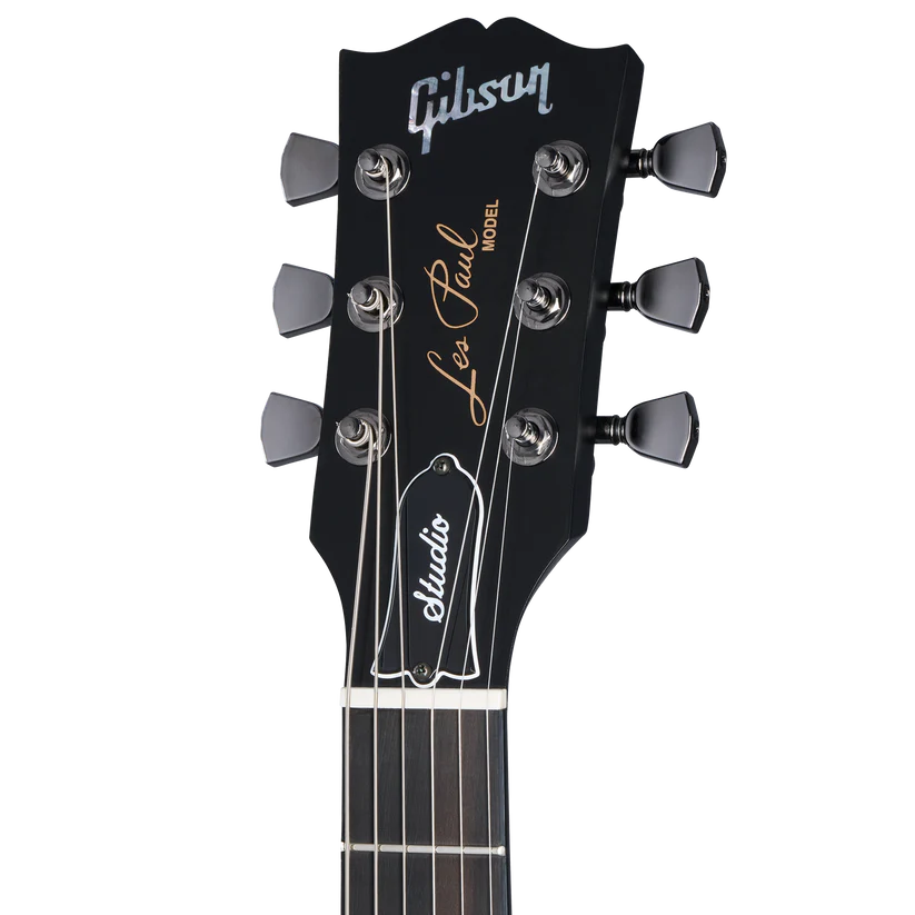Black headstock of a Gibson Les Paul Studio electric guitar with silver tuners and gold Les Paul signature text.
