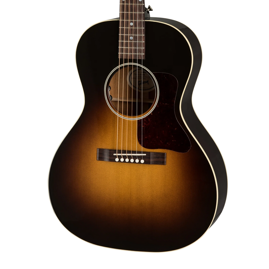 Sunburst-finish acoustic guitar with a dark outer edge, lighter brown center, white trim, tortoiseshell pickguard, and six strings.