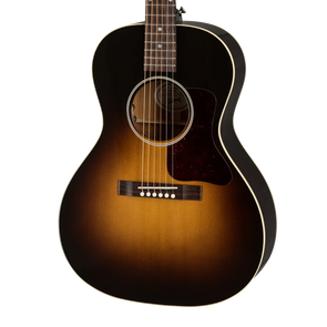 Sunburst-finish acoustic guitar with a dark outer edge, lighter brown center, white trim, tortoiseshell pickguard, and six strings.