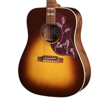 Sunburst Gibson acoustic guitar with a detailed pickguard featuring white bird and floral designs.