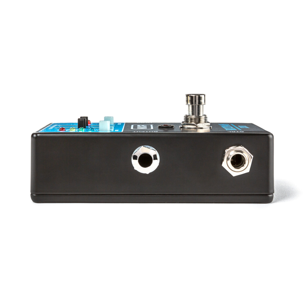 Rectangular FX pedal with two metal input/output jacks and a round metal footswitch on top, plus control knobs visible on the upper surface.