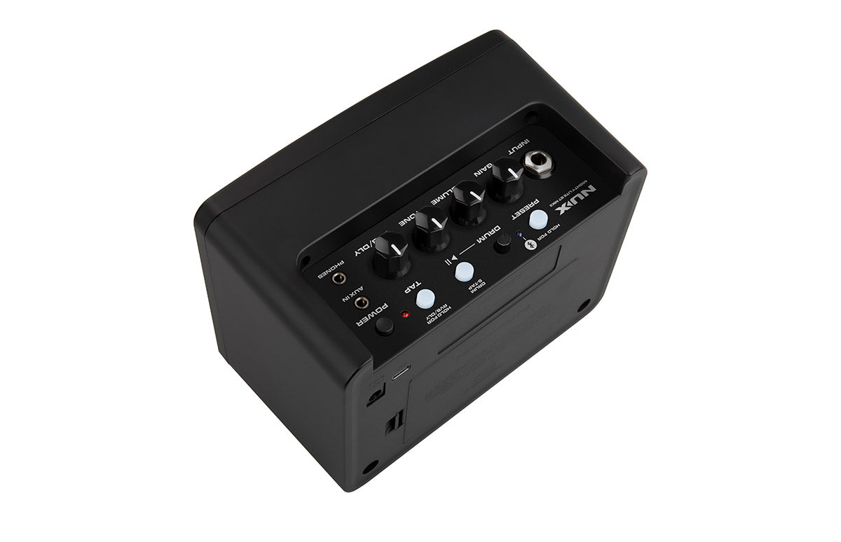 Small black amplifier with four control knobs, multiple input jacks, and several buttons labeled for functions like drum, tap, and reset.