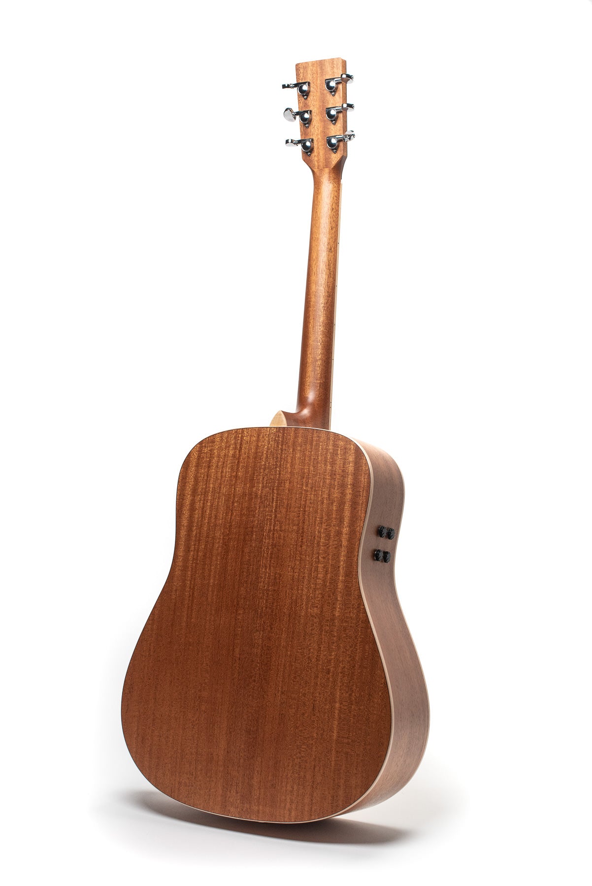 Back view of a wooden acoustic guitar showing six tuning pegs, smooth mahogany finish, and side control knobs near the neck.