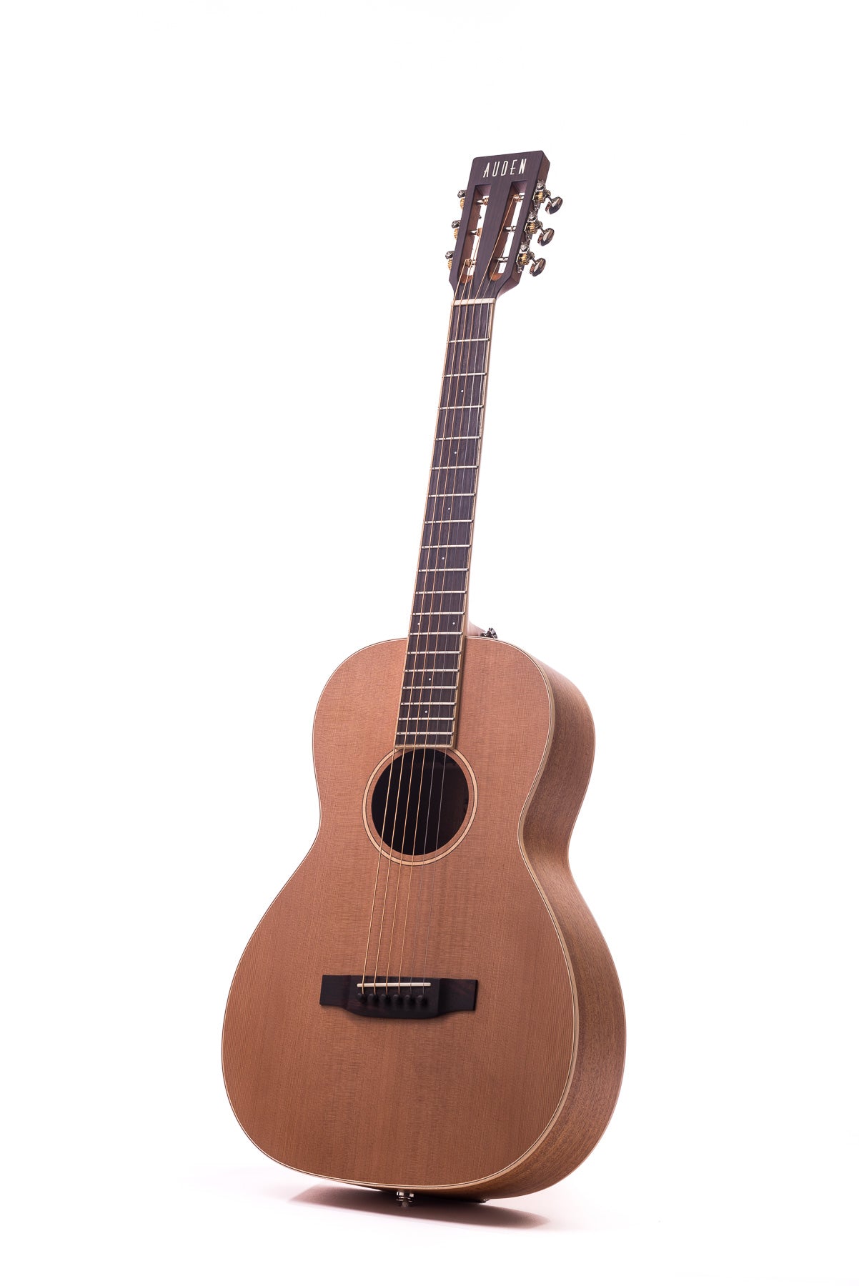 Light brown acoustic guitar with six strings, a round sound hole, dark bridge, and headstock labeled "Auden" in white letters.