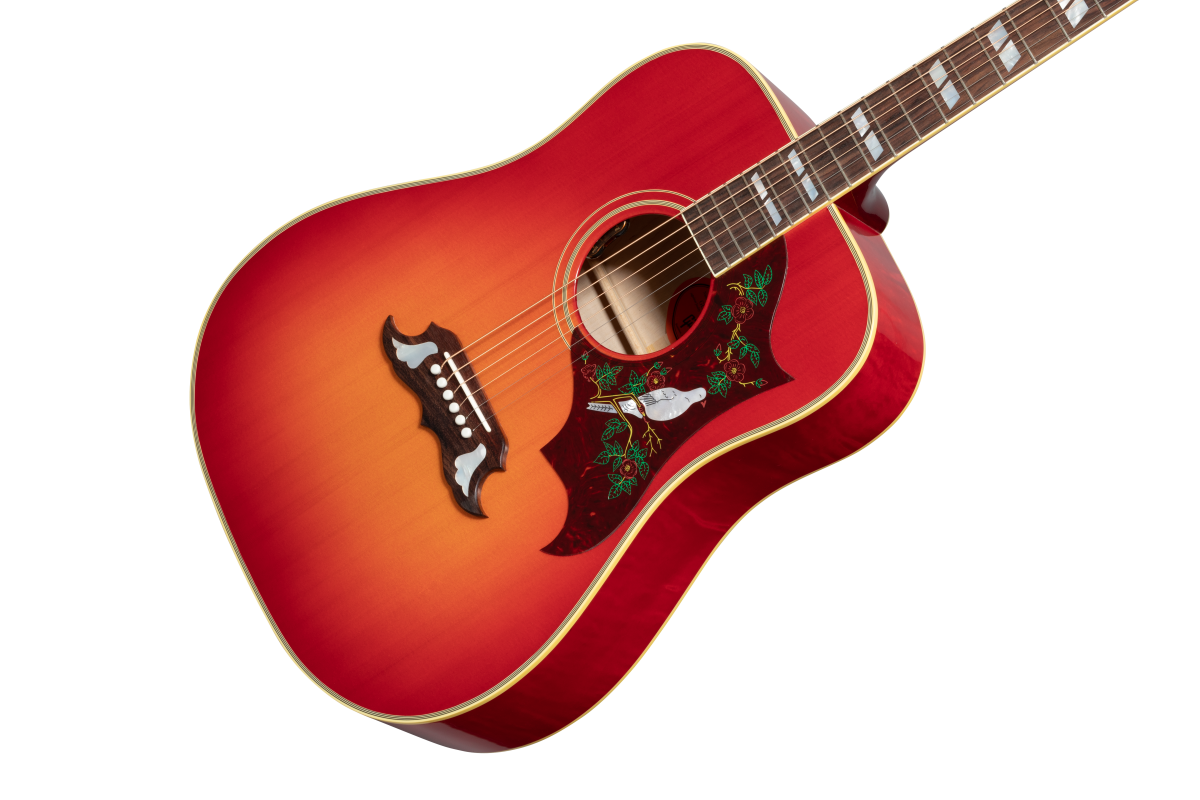 Red-to-orange sunburst acoustic guitar with intricate pickguard art of a white bird and green vines, decorative bridge inlays, and block fretboard markers.
