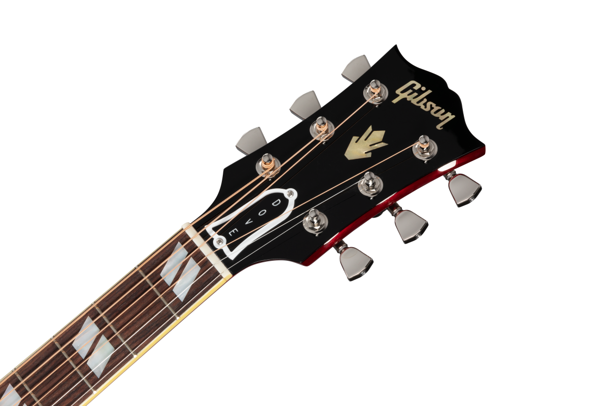 Gibson acoustic guitar headstock with gold logo, six silver tuning pegs, and "DOVE" truss rod cover; fretboard has large diamond inlays.