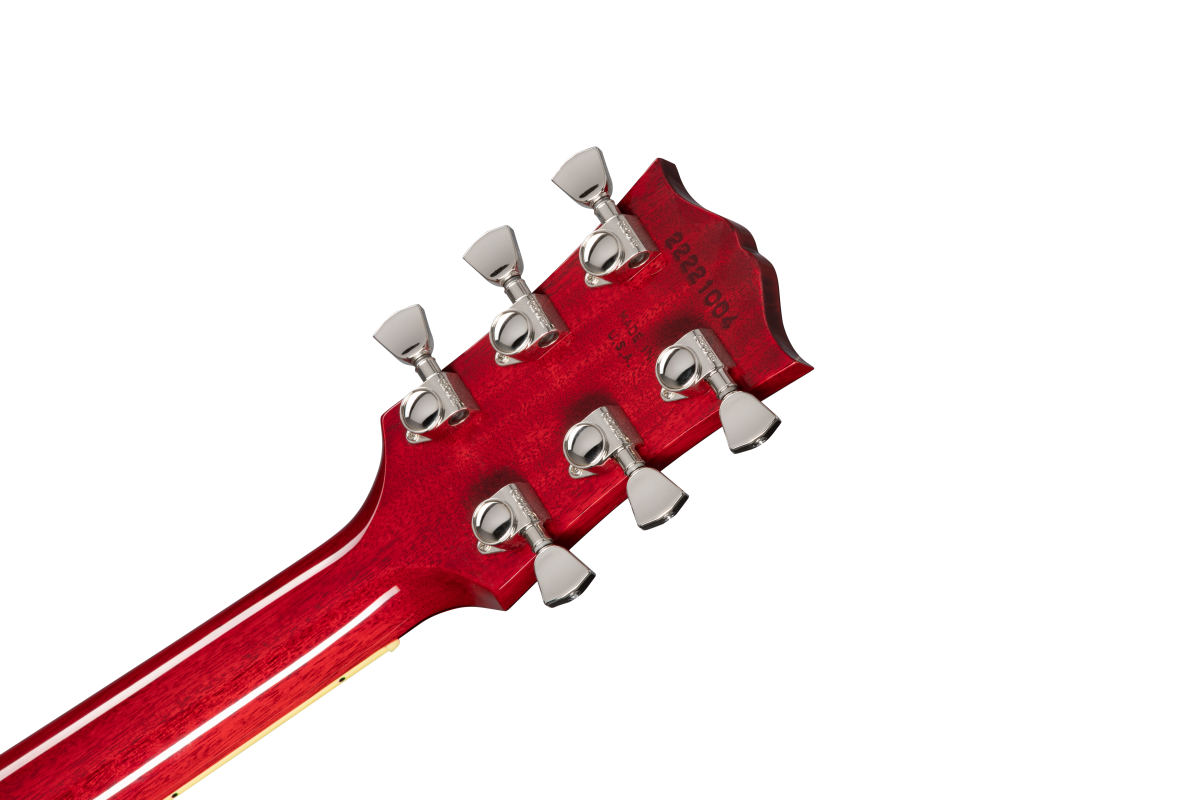 Red acoustic guitar headstock with six silver tuning pegs, viewed from the back; serial number and manufacturer text visible.