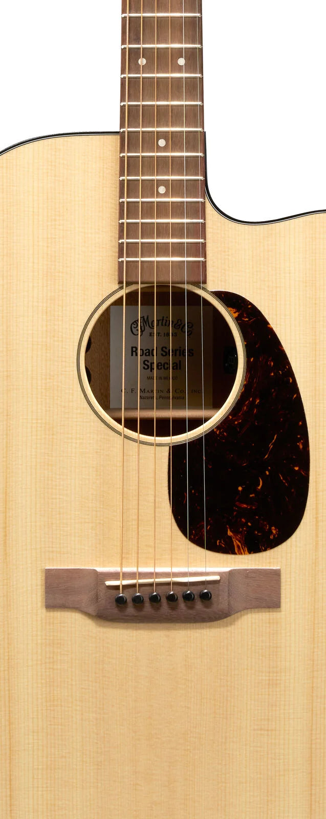 Acoustic guitar with a light wood body, dark pickguard, six strings, round soundhole, and a visible label reading "Road Series Special."