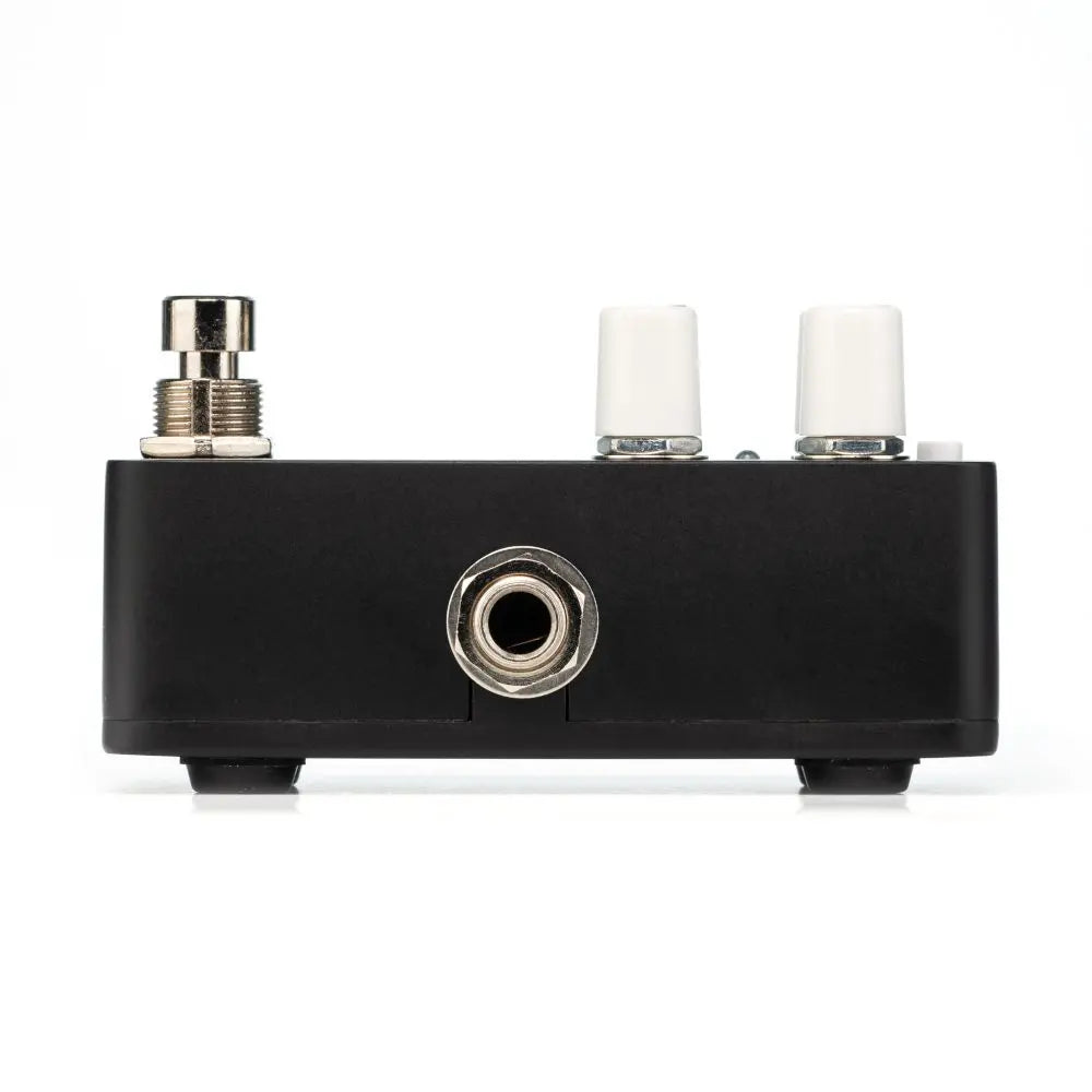Black FX pedal with one footswitch, two white control knobs, and a single central input/output jack on the front panel.
