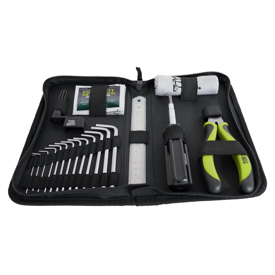 Zippered tool kit holds hex keys, a screwdriver, pliers with green handles, a small ruler, and other bike maintenance accessories in elastic straps.