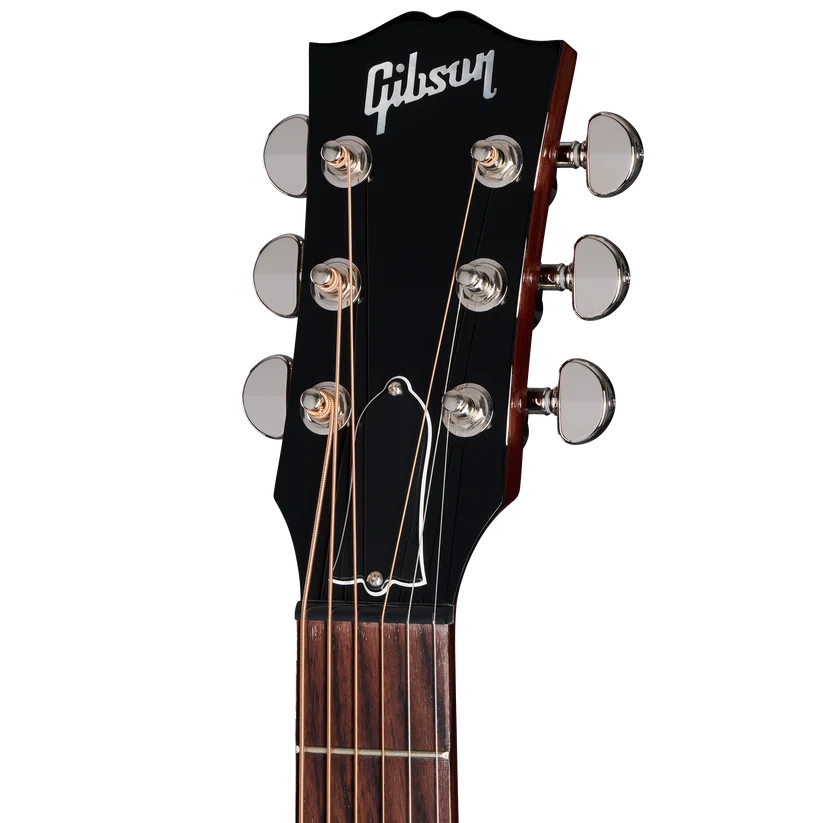 Tête de guitare électrique noire Gibson, six mécaniques chromées alignées, logo Gibson blanc au sommet, cordes tendues visibles.