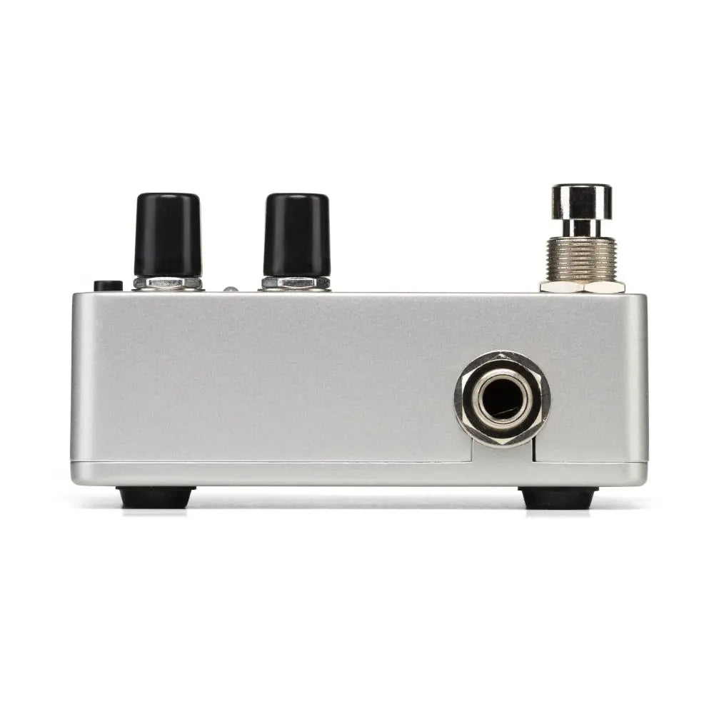 Compact silver FX pedal with two black control knobs, a metal footswitch, and a single 1/4-inch input jack on the side.