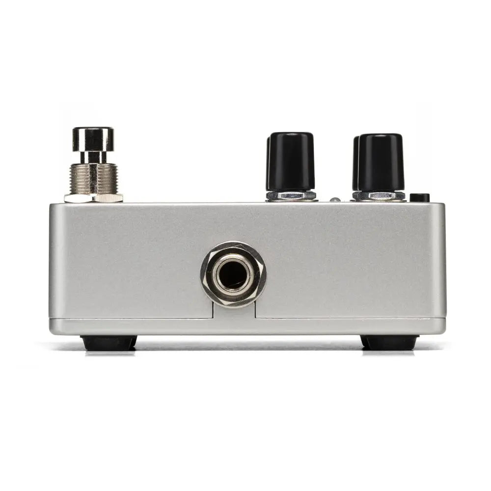 Silver FX pedal with a footswitch on the left, two black control knobs on top, and a central input jack on the front panel.